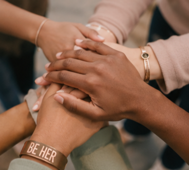 Multiple hands layered together, symbolizing unity and support.