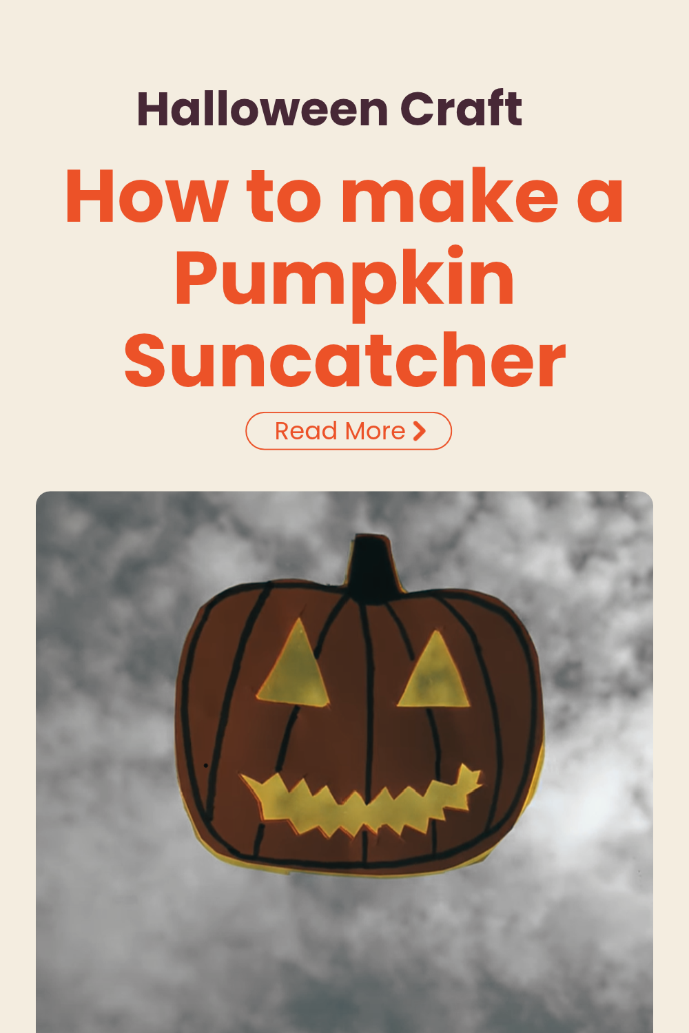 Orange paper pumpkin suncatcher on a window, with sunlight shining through its yellow eyes and zigzag mouth. Text reads “Pumpkin Sun Catcher: Alternative Halloween Craft for Kids”.
