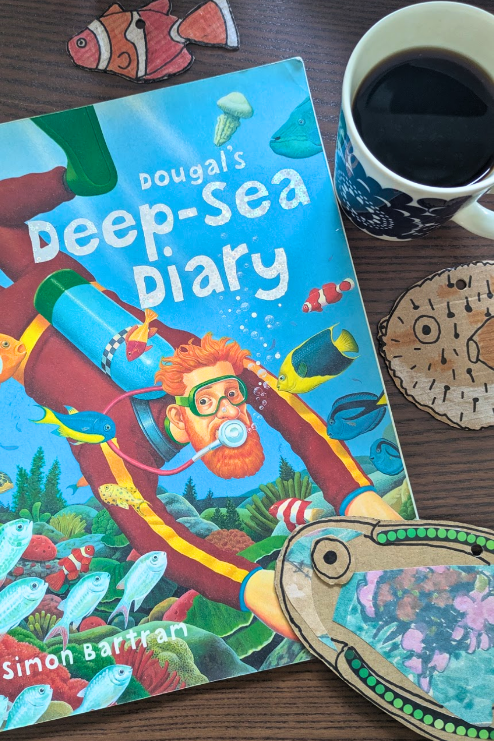  Colourful cardboard fish craft beside the children's book Dougal's Deep-Sea Diary. 
