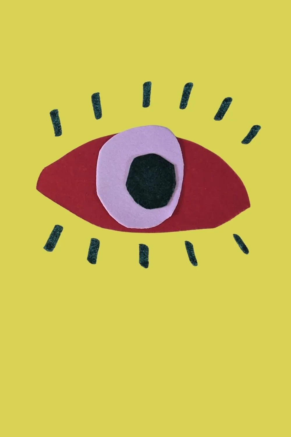 An eye made from cutting simple red, purple and dark shapes and assembling them on a on a mustard green background.