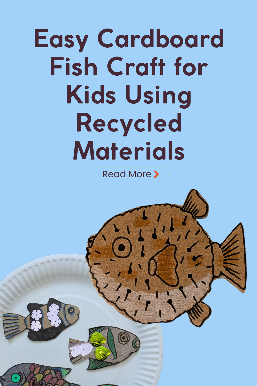 Colourful handmade cardboard fish craft for kids made from recycled cardboard, with a large cardboard pufferfish.