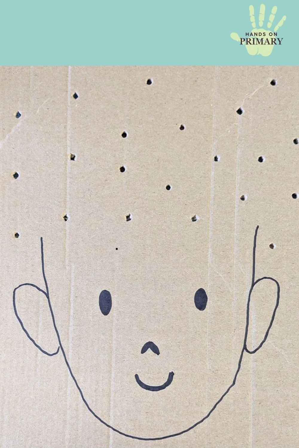 A cardboard face with holes in the cardboard where the hair is.