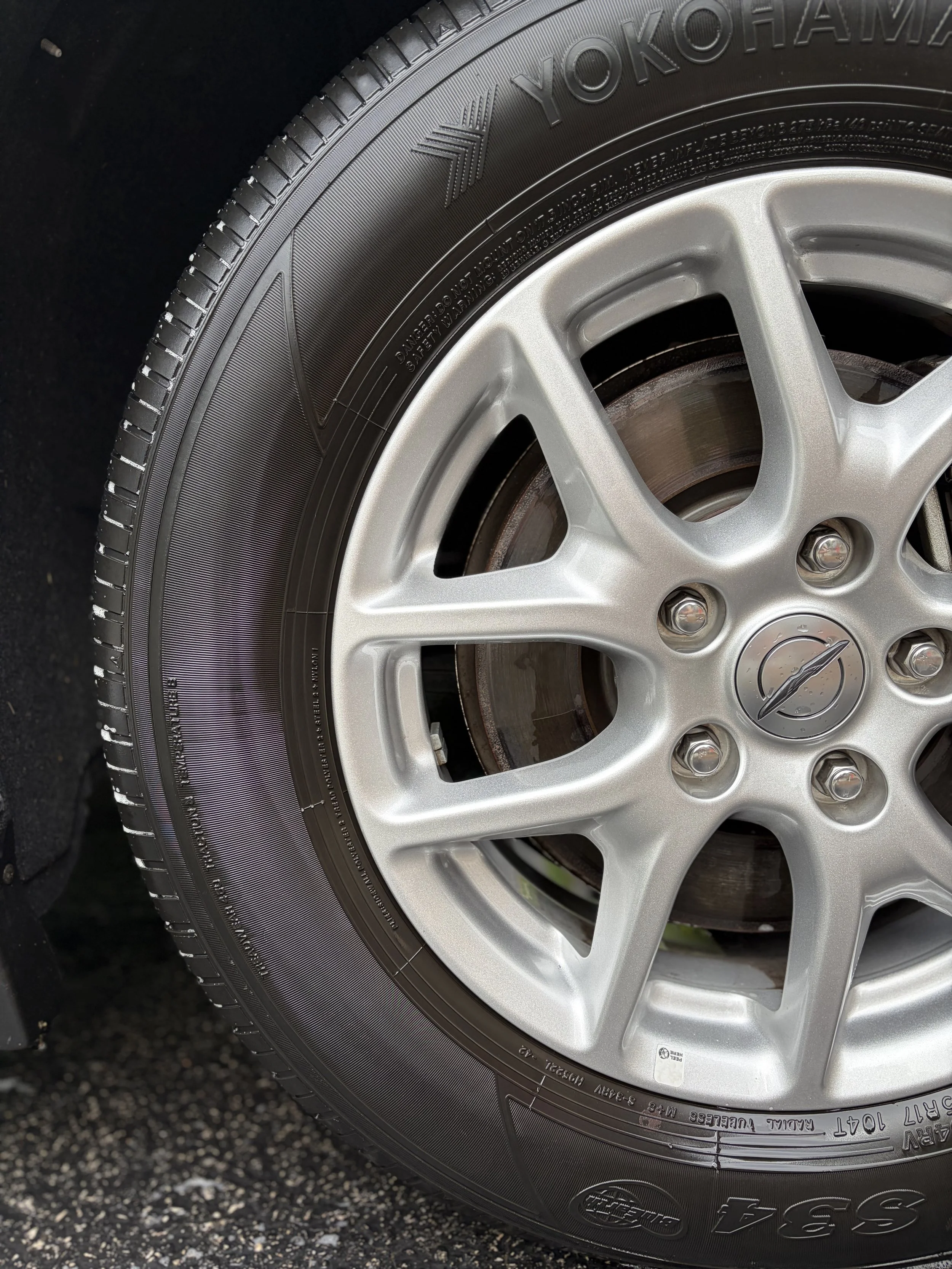Close-up image of a tire mounted on a silver alloy wheel, with the brand name 'Yokohama' visible on the sidewall.