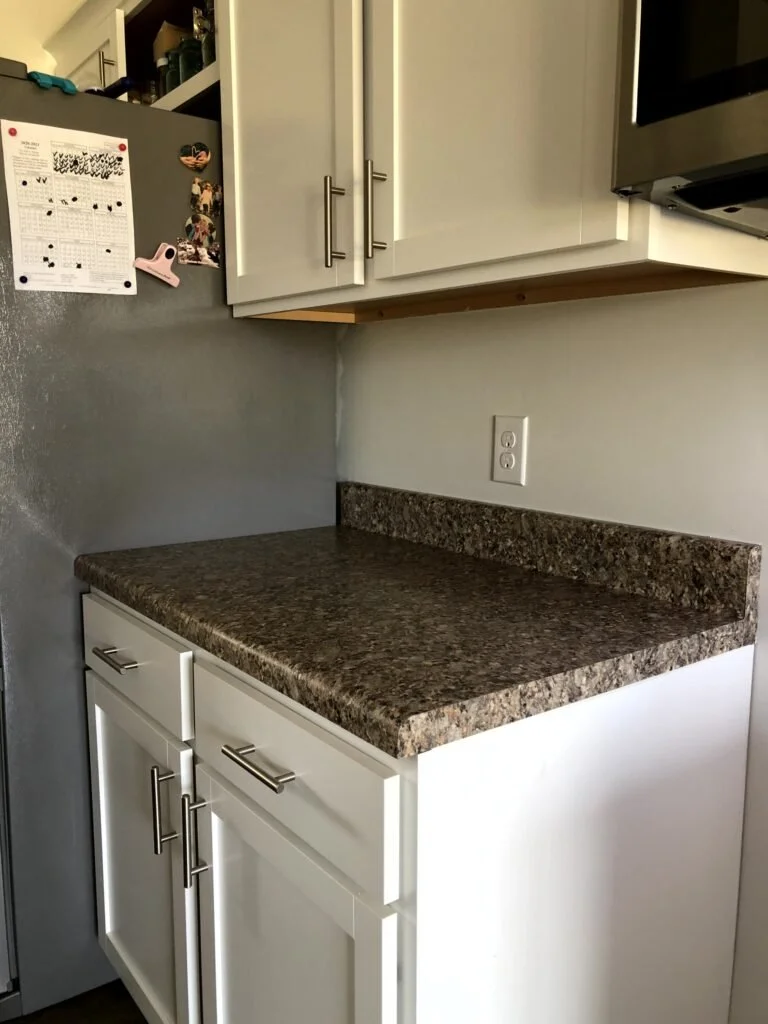 Brown counters white cabinets