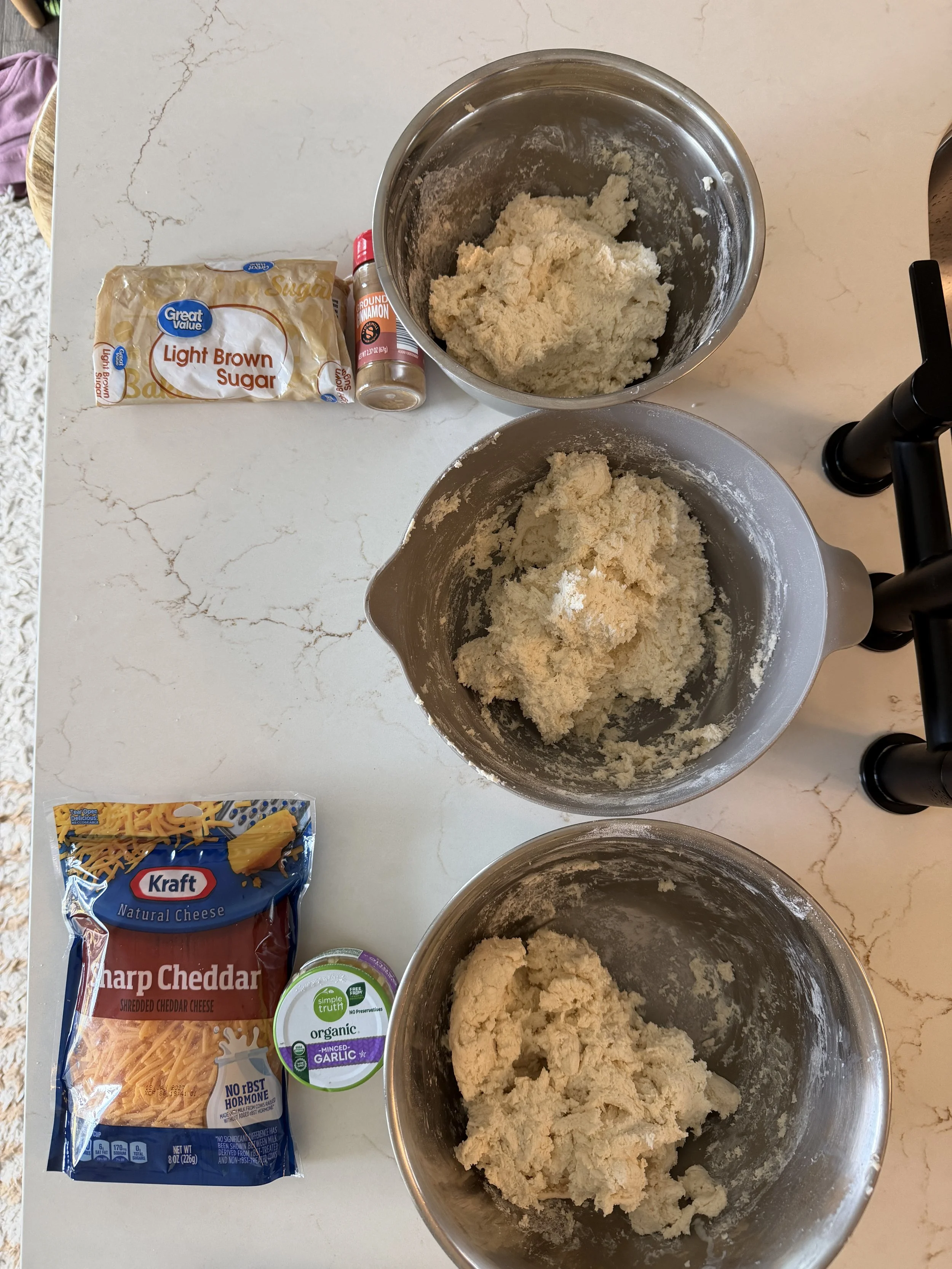 Three bowls of biscuit dough
