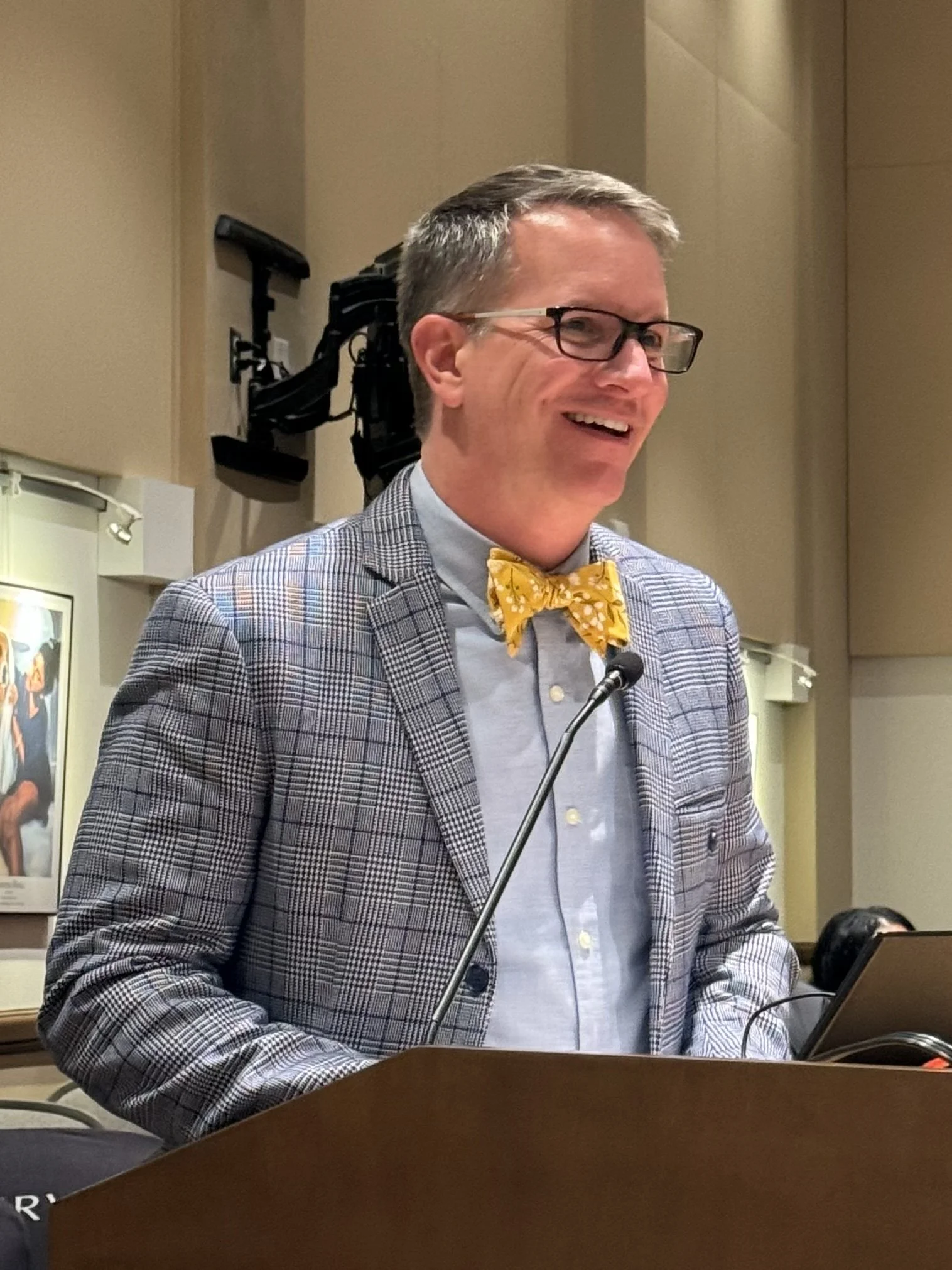 Guy Swenson Ed.D. speaking at a podium as an educational leader in Orlando Florida