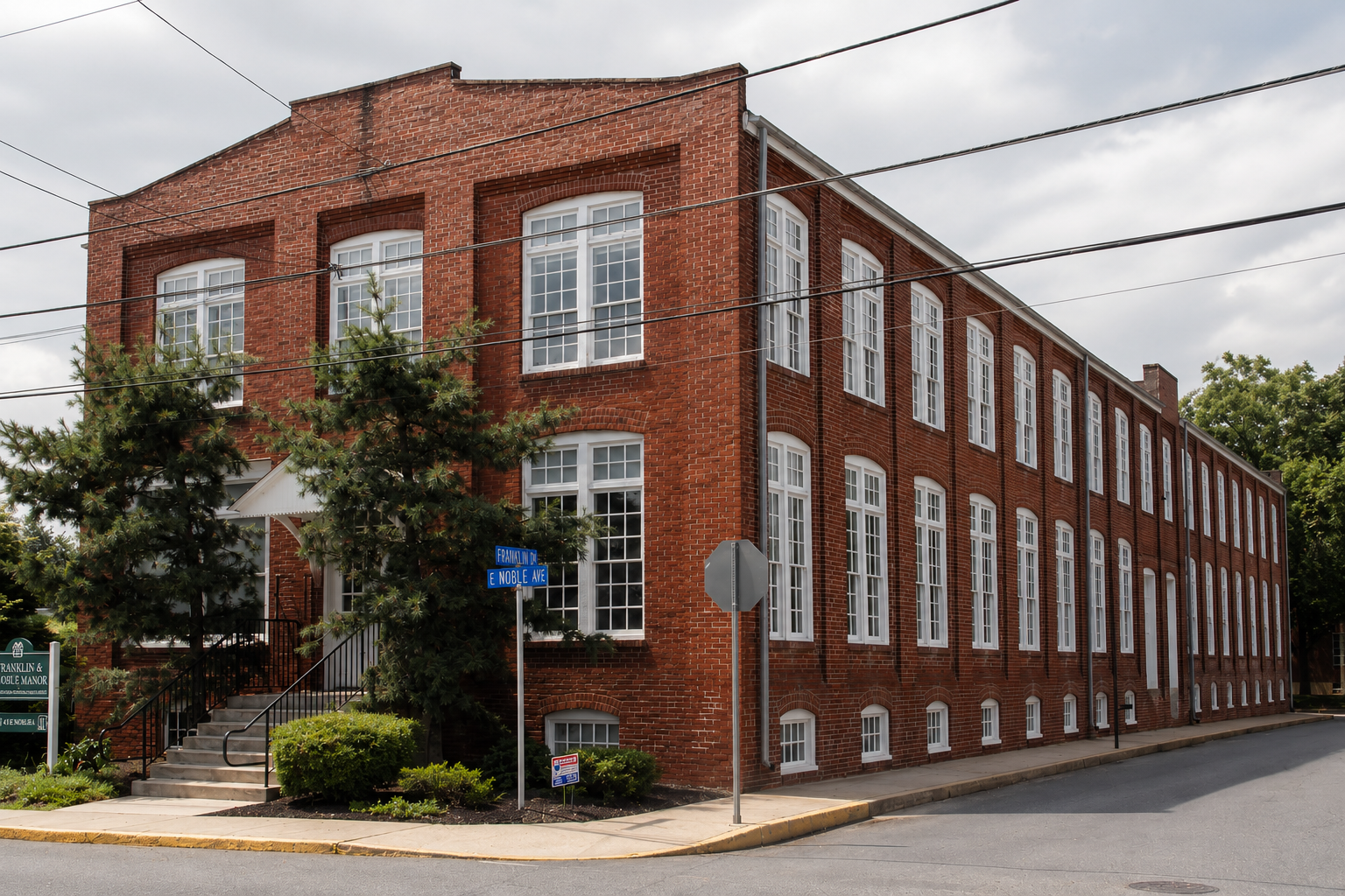 A multi-story red brick apartment community.