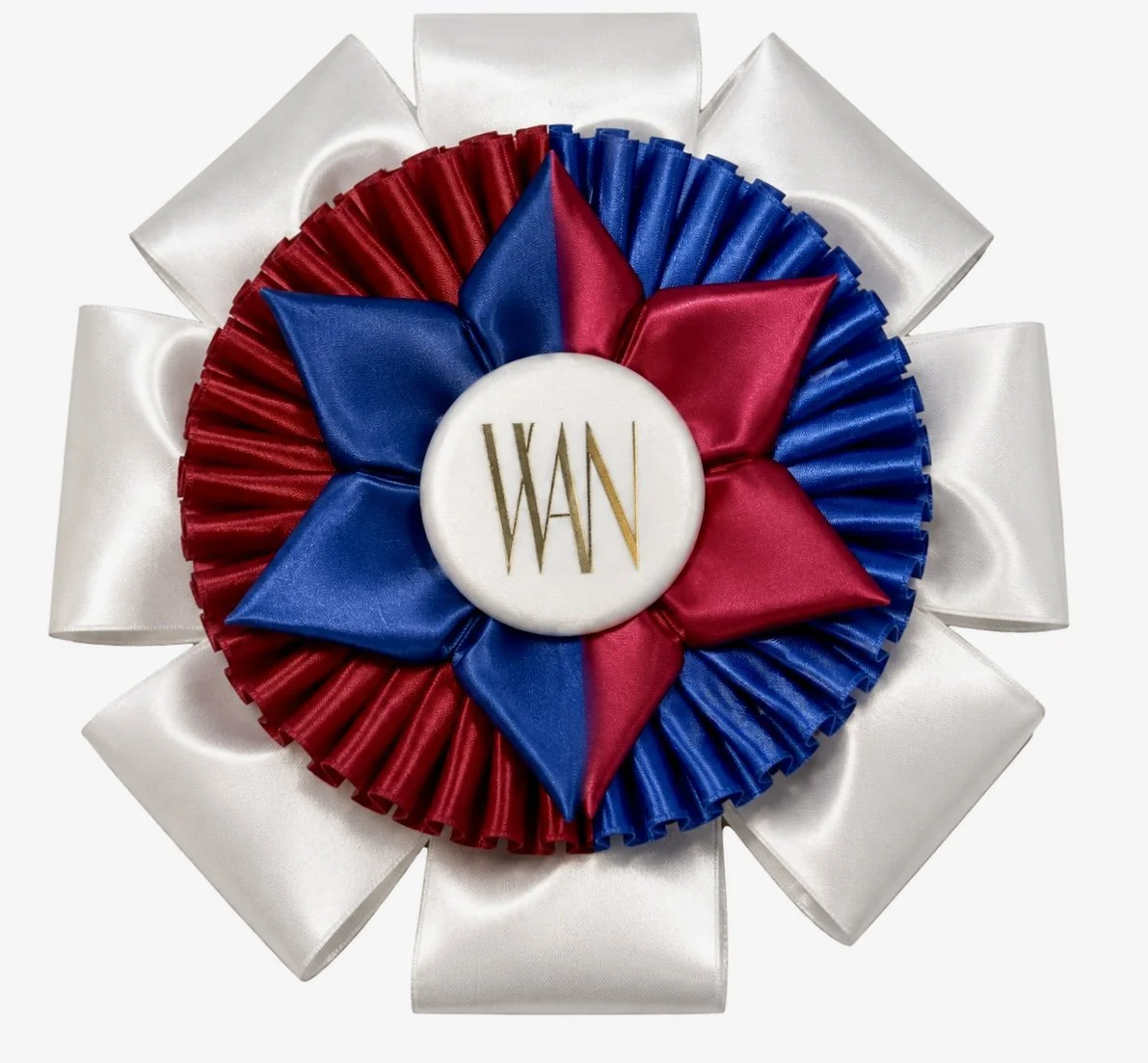 Red, white, and blue rosette ribbon with a central medallion that has gold text reading WANN, surrounded by white satin ribbons.