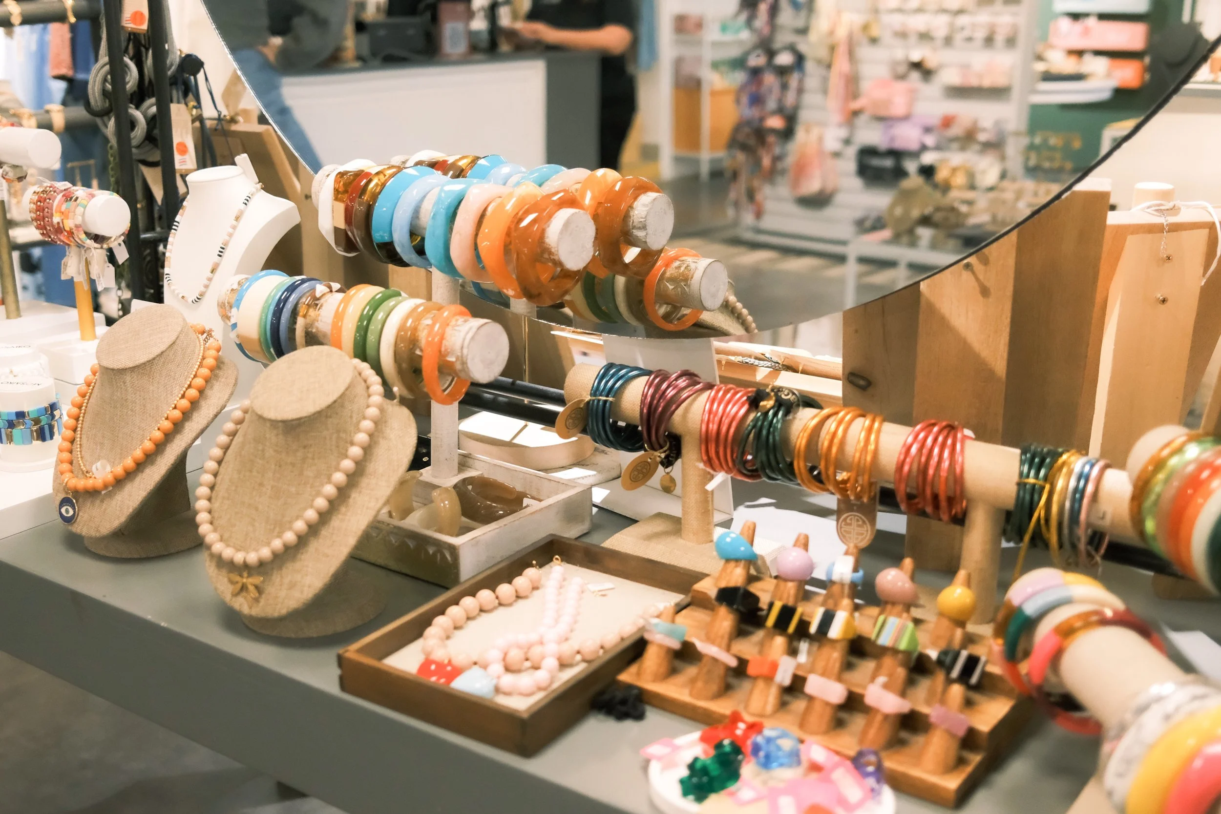 Colorful jewelry displayed on a table at Apartado Creativo — retail styling by OLA