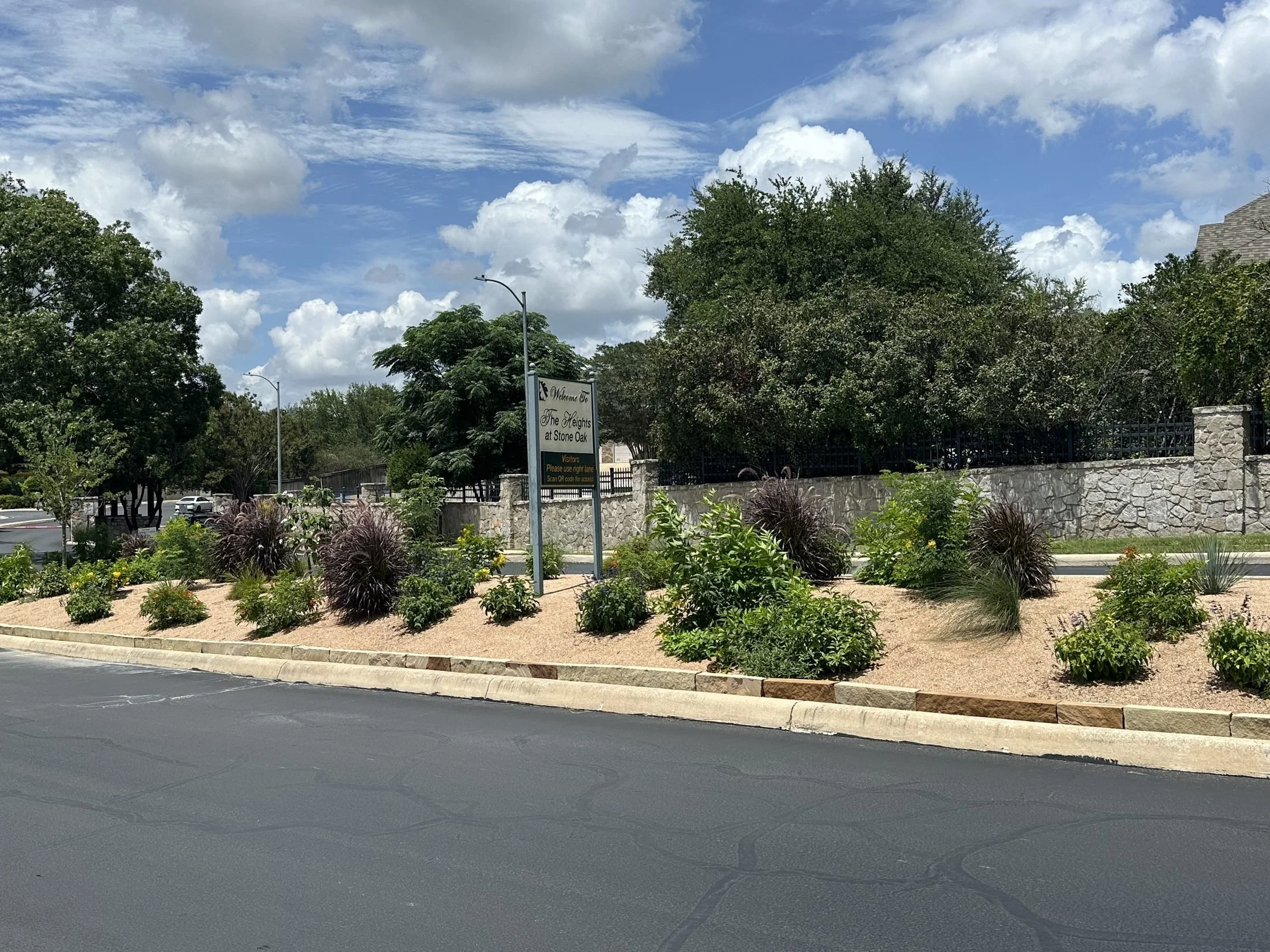 Planned entrance landscape with layered plantings at the Heights at Stone oak in San Antonio