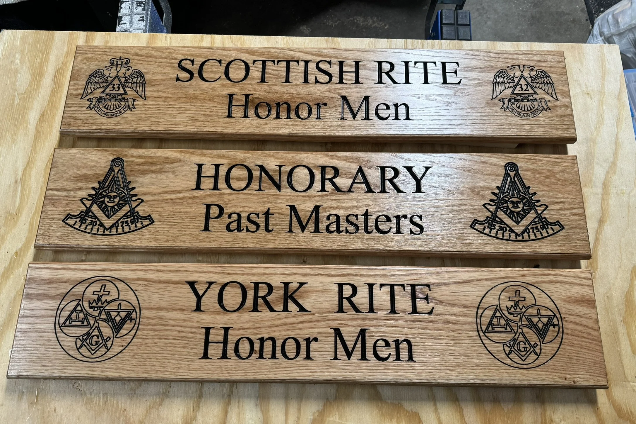 Wooden plaques with engraved and painted Masonic symbols and text. The top plaque says 'SCOTTISH RITE Honor Men,' and the bottom plaque says 'HONORARY Past Masters.' Each plaque features Masonic emblems with various symbols and numbers.