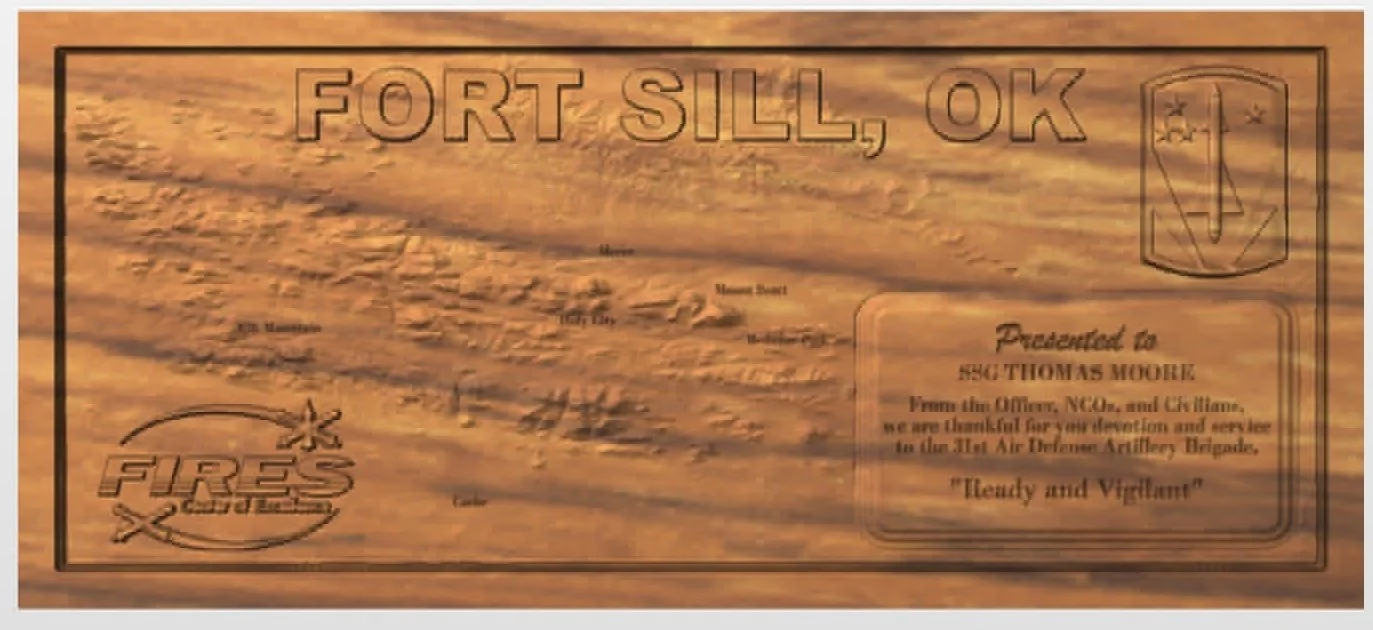 Wooden plaque with engraved map and text honoring Fort Sill, Oklahoma, and featuring a fire rescue emblem, dedicated to Thomas Moore, expressing gratitude for service in the Air Defense Artillery, with the motto "Steady and Vigiliant".