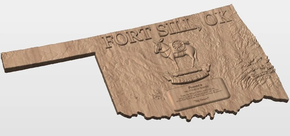 A carved wooden plaque of the Oklahoma state flag featuring a scimitar, Osage warrior, and wheat streamers, with the inscription 'Fort Sill, OK'.