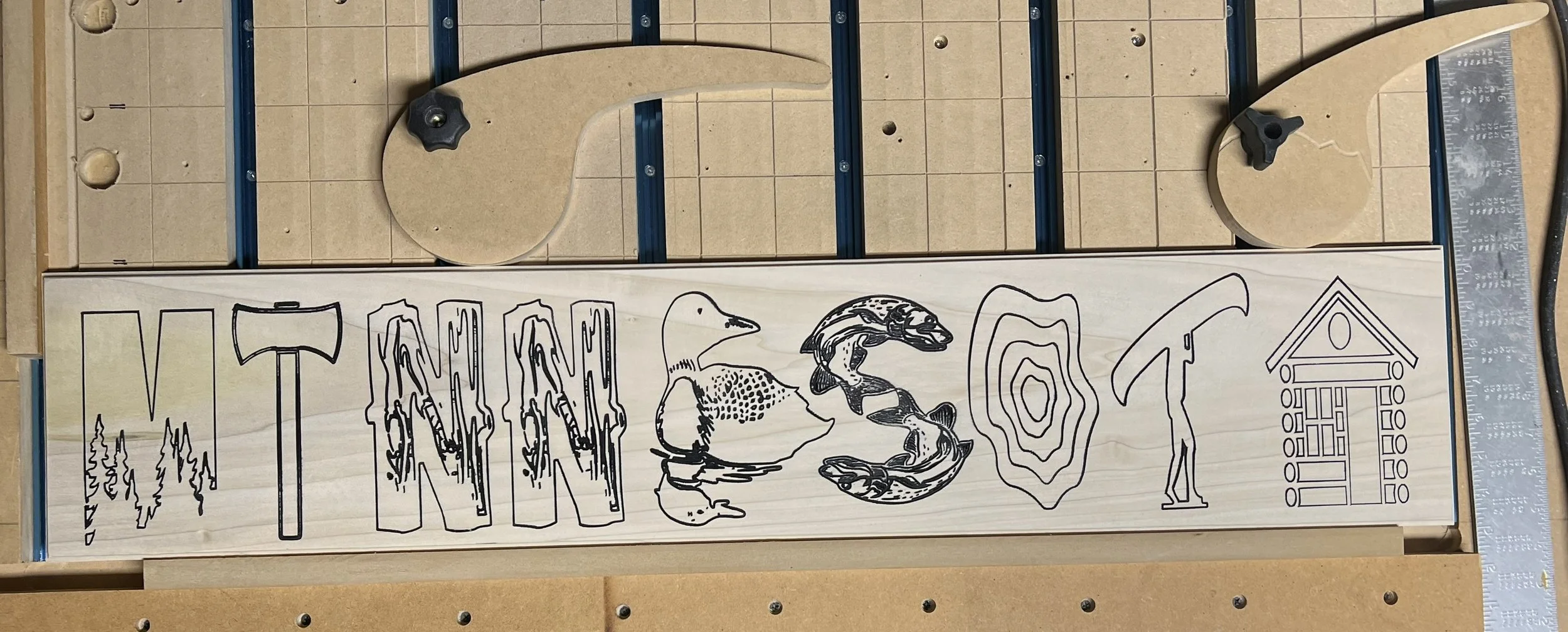 A wooden sign with artwork and the word 'WILD' in large letters, alongside nature-themed illustrations such as a bear paw, animal tracks, a bear, and a cabin, all set against a tiled background with some metal frame elements.