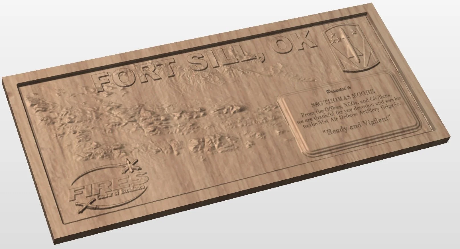 Wooden plaque with engraved map of North Carolina, the words "Fort Sil~" at the top, a shield emblem with a star and banner, and a quote in a rectangular box reading "Readiness and Vigilant". There is text indicating it was presented to SSI Thomas Mo