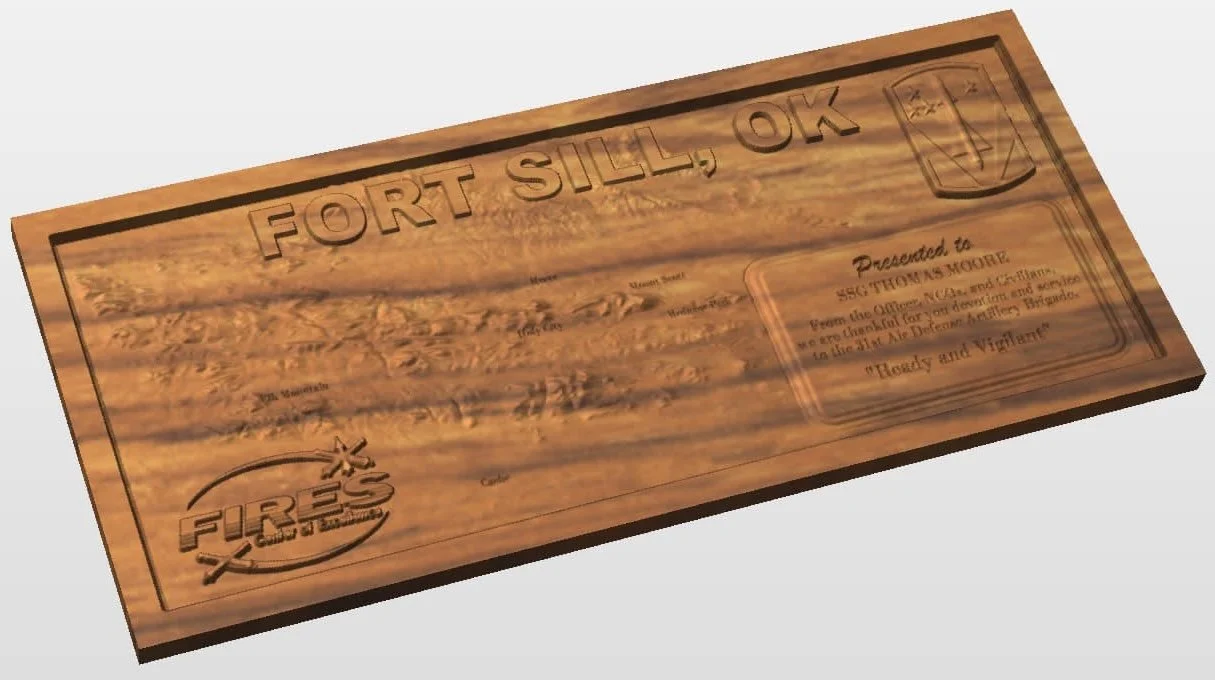 Wooden plaque with the words "Fort Sill, OK" engraved on top, and a Fire Department logo at the bottom left. The plaque has engraved text and a shield symbol on the top right corner.