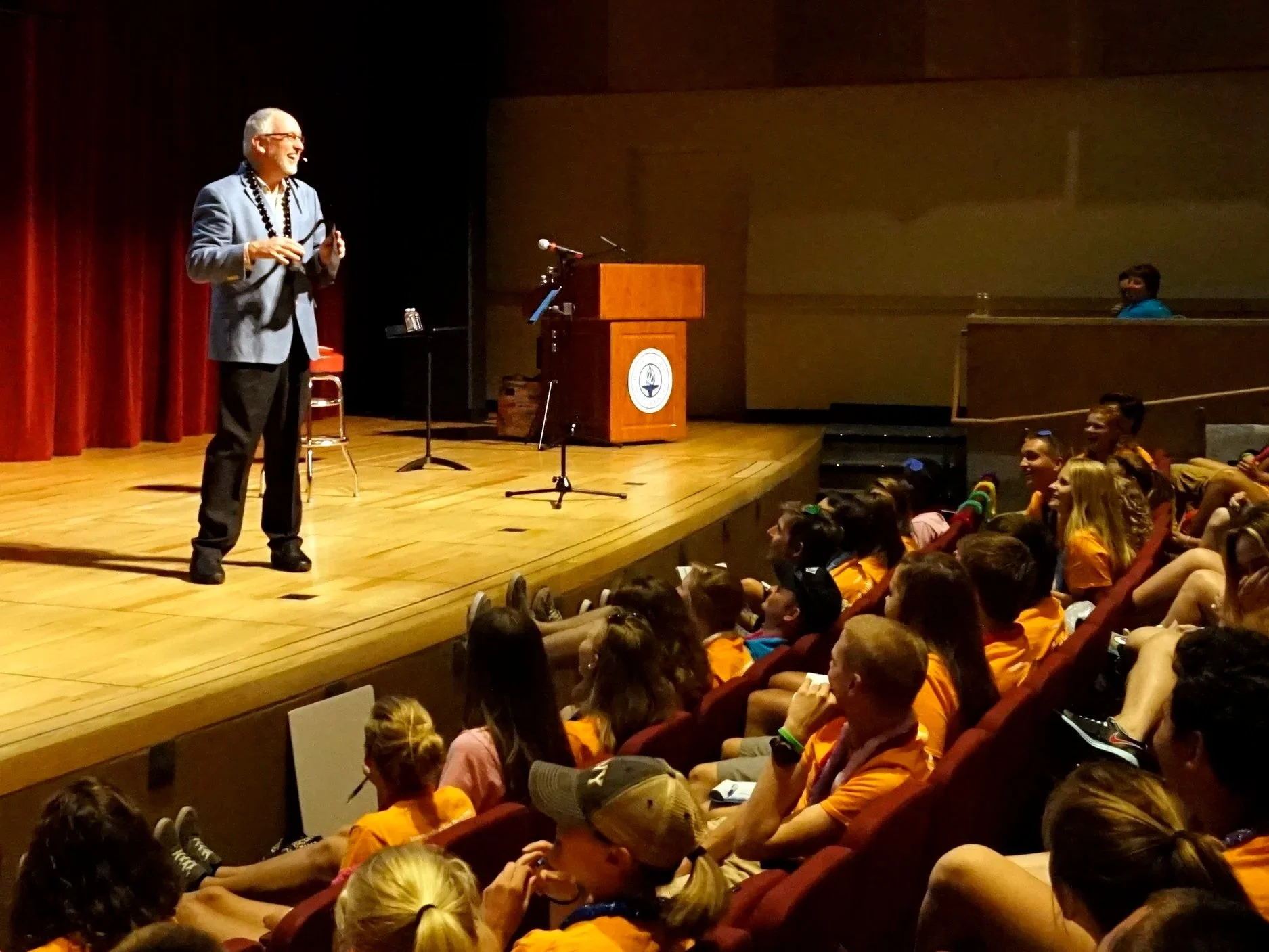 Kevin Wanzer address a young audience in an auditorium