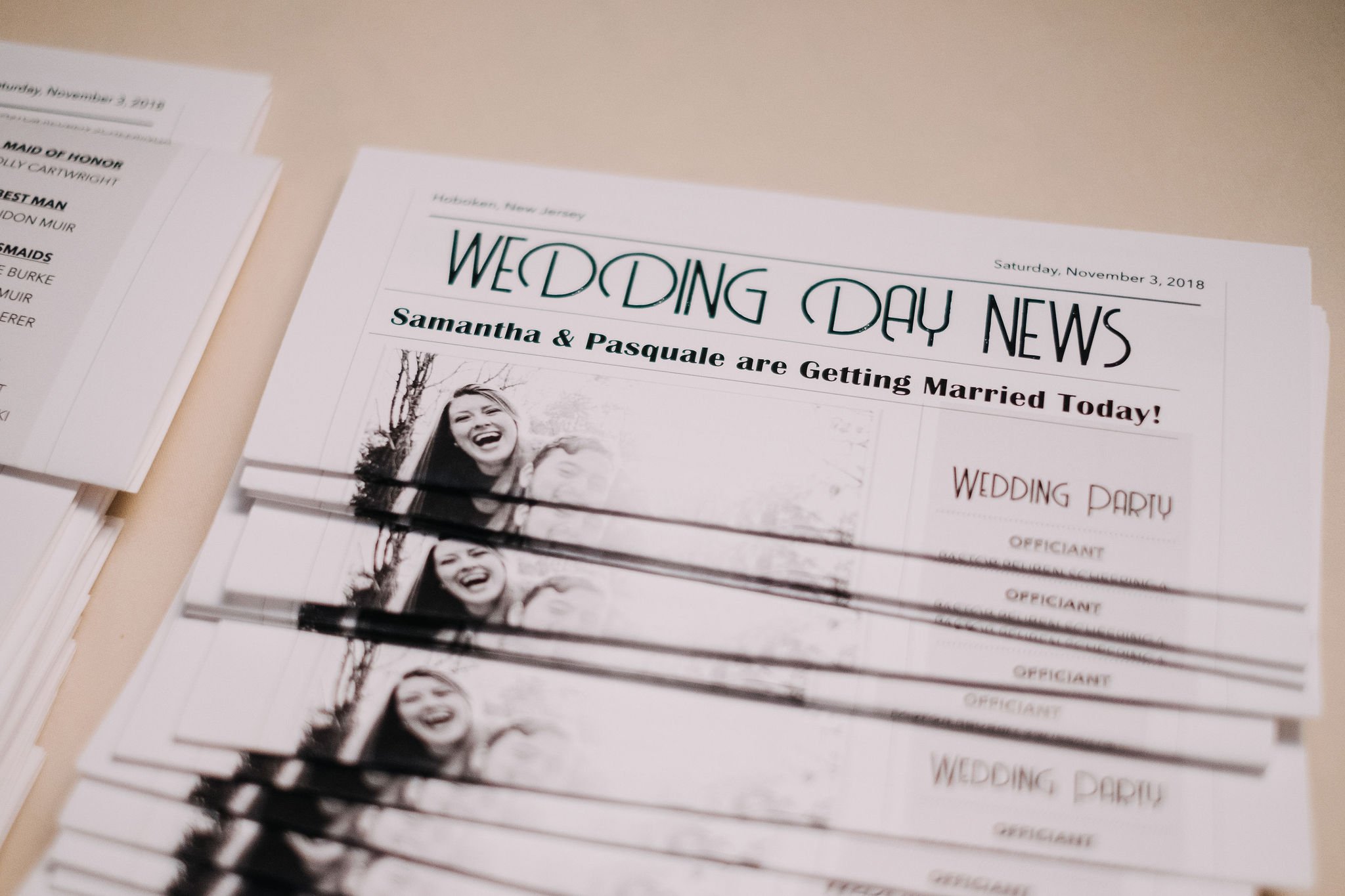 Stack of wedding day news sheets with black and white photo of smiling woman, heading 'Wedding Day News', date November 3, 2018, with content about Samantha and Pasquale's wedding.