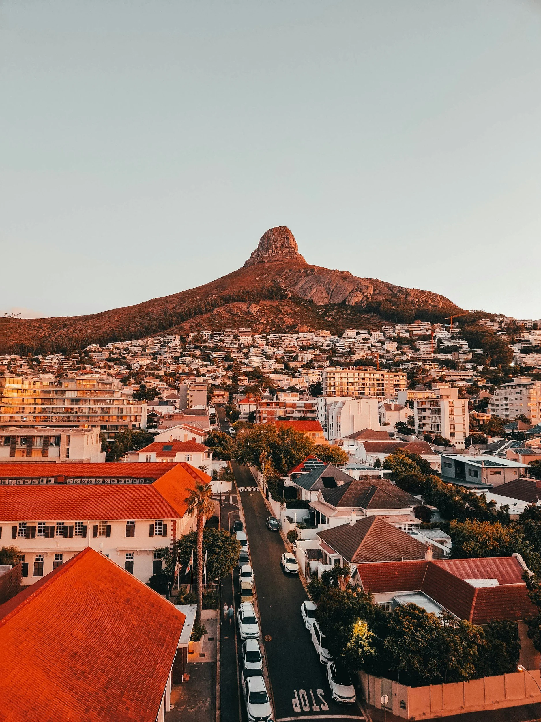 A hillside cityscape during sunset with a look on the Table Mountain in Cape Town, South Africa.