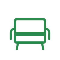 Outline of a green armchair with armrests and four legs.