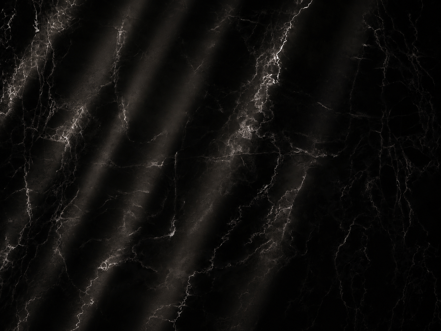 Dark marble surface with white and gray veining and lightning patterns.