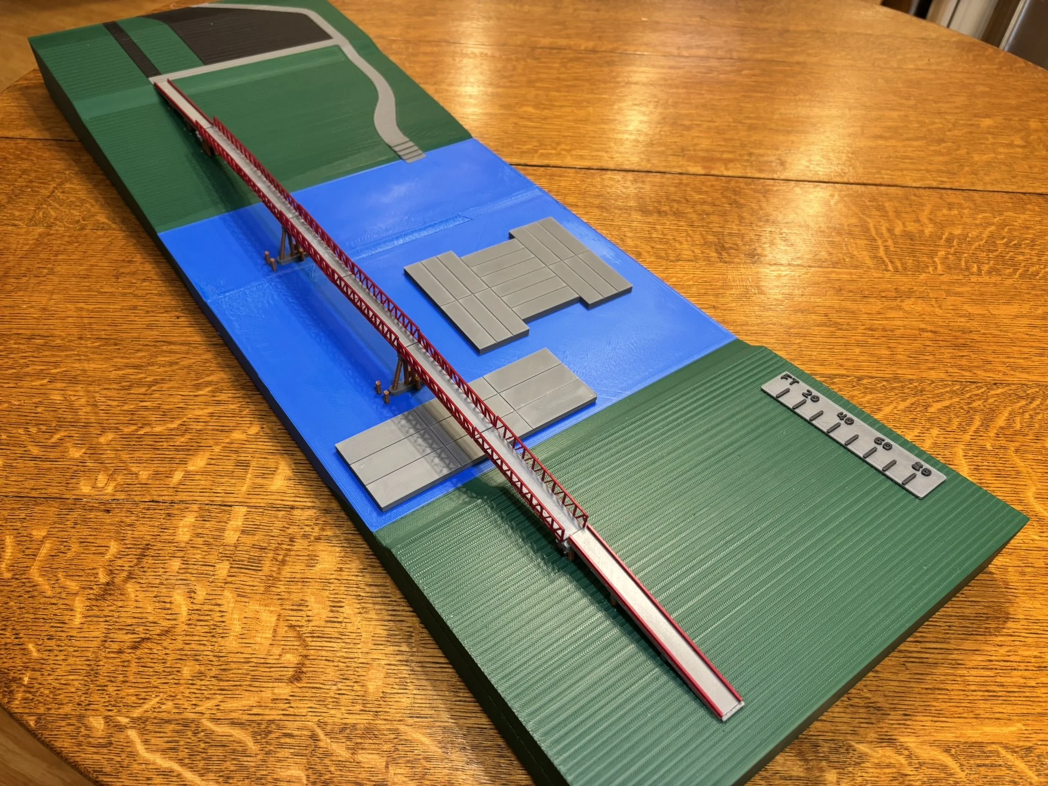 3D printed model of a bridge over a river complete with removable bridge spans and barges.