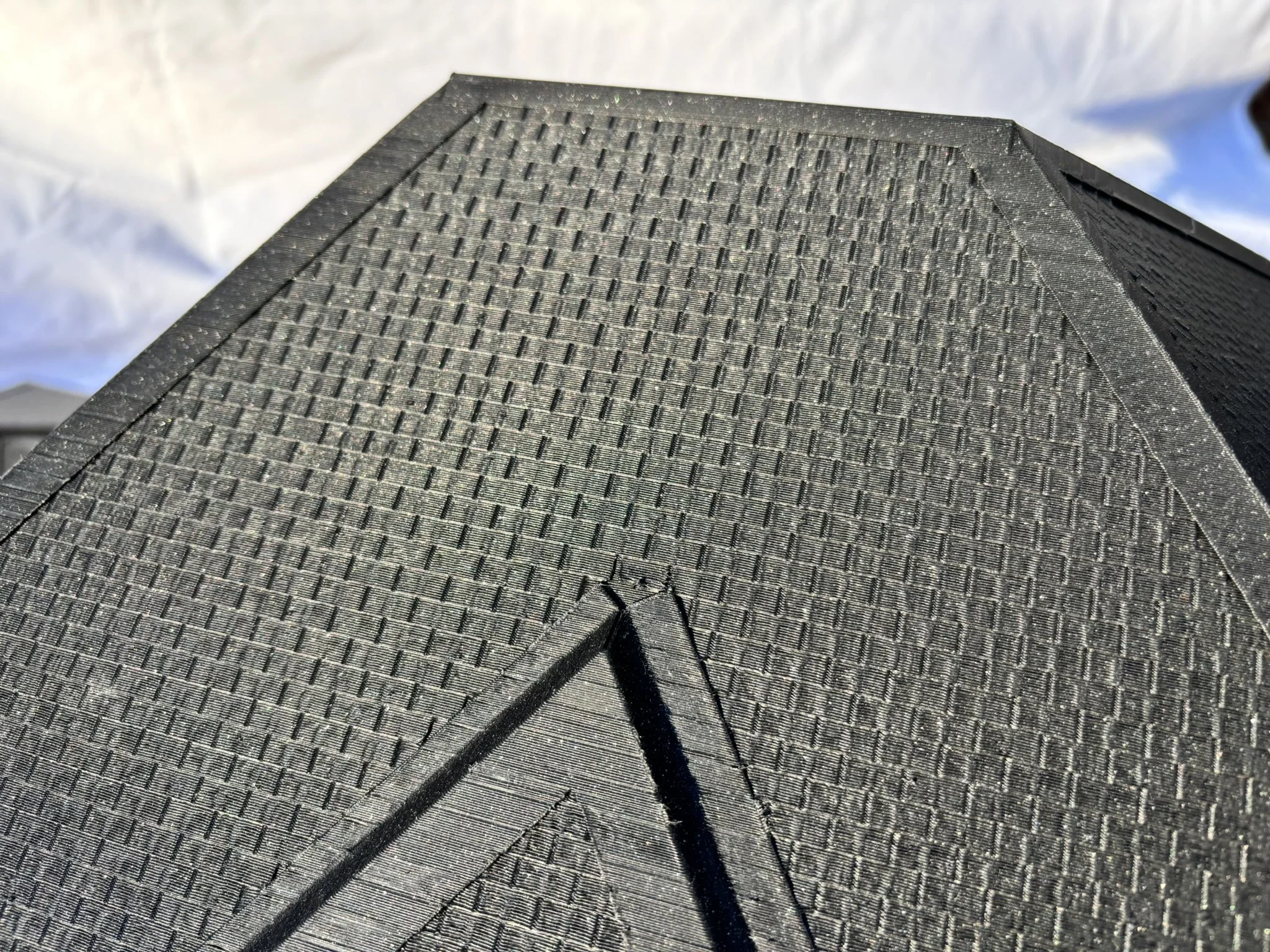 Close-up view of the shingle textures of the red brick house.