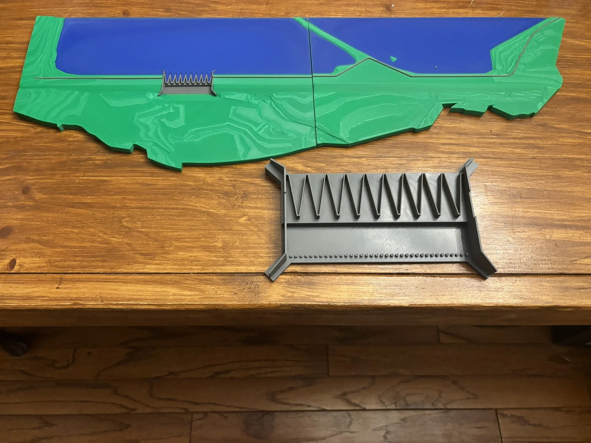 A model of a landscape featuring a dam, river, and terrain.