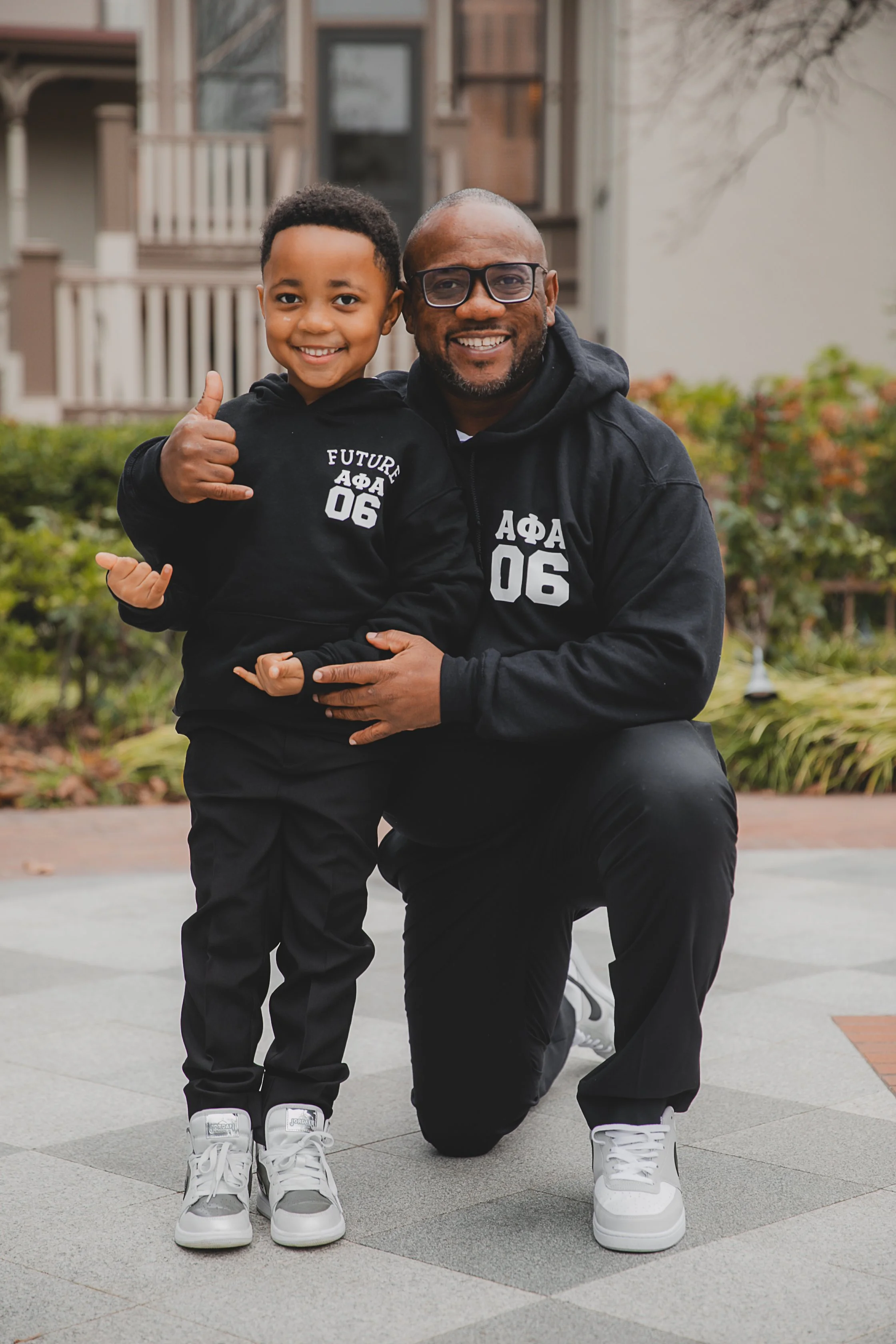 Malonn Barnes and his son Isaiah with matching hoodies representing fraternity Alpha Phi Alpha