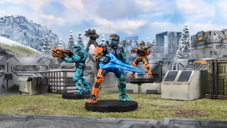 Miniature soldiers in futuristic armor with weapons, set on a terrain with a mountain background and trees, resembling a sci-fi battle scene.