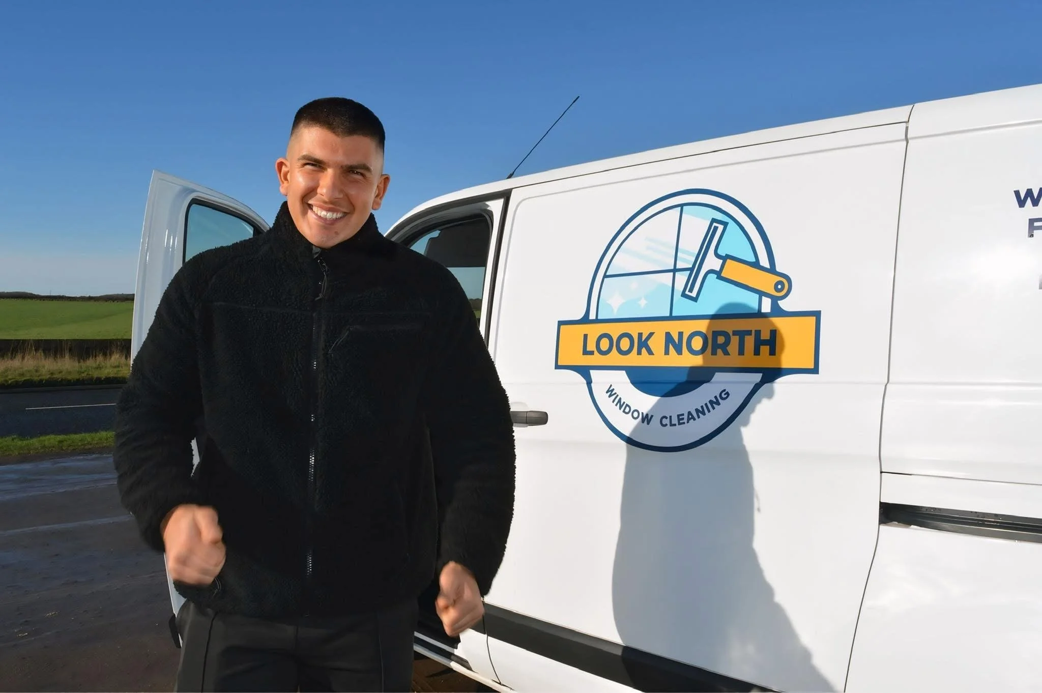 A professional, reliable and trusting young man next to a white van for "Look North Window Cleaning" in Newcastle Upon Tyne.