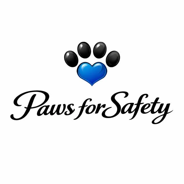 A logo with black paw prints, a blue heart, and the words "Paws for Safety" in black cursive font.