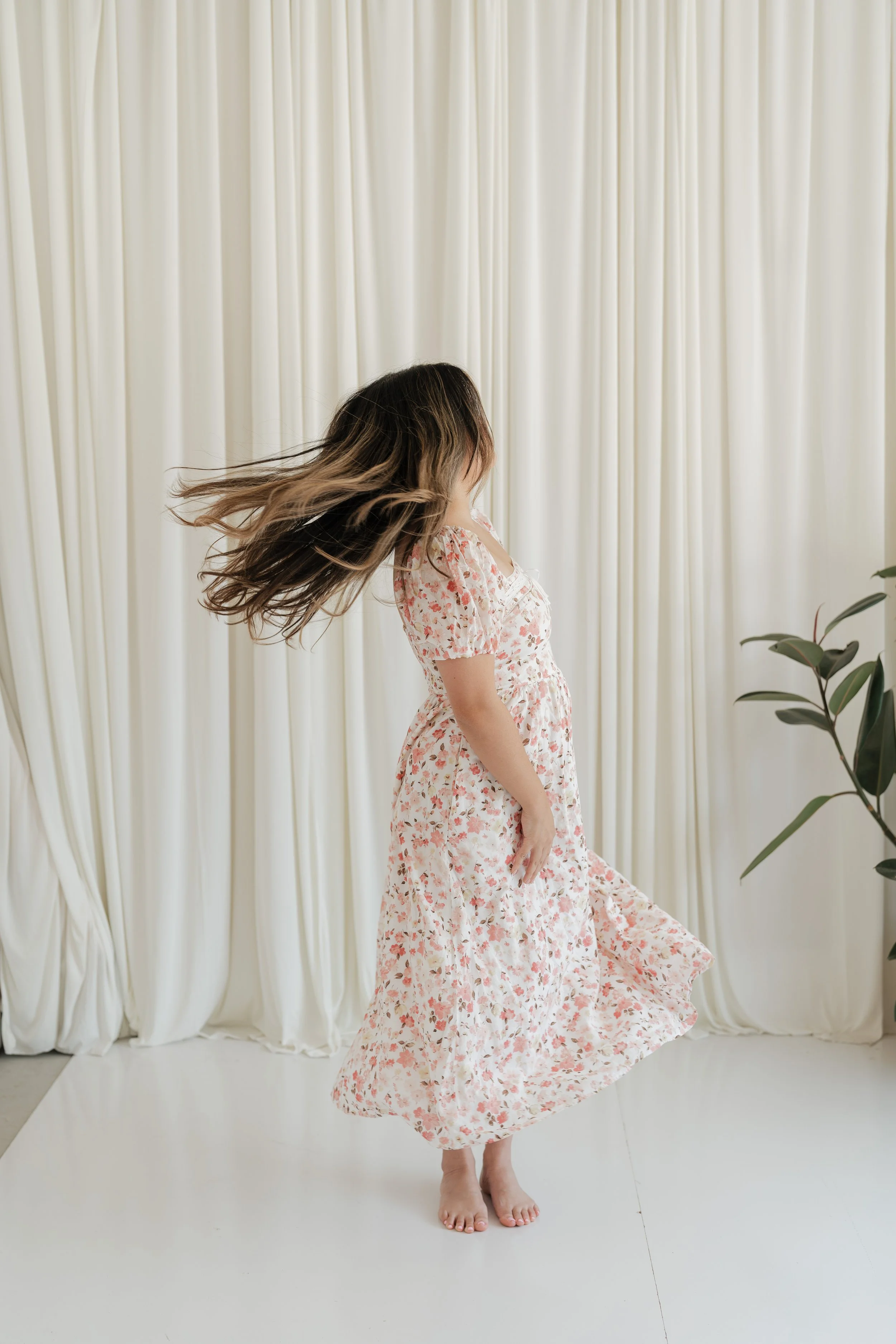 Minh Ngo twirling in a floral dress, Texas therapist for women