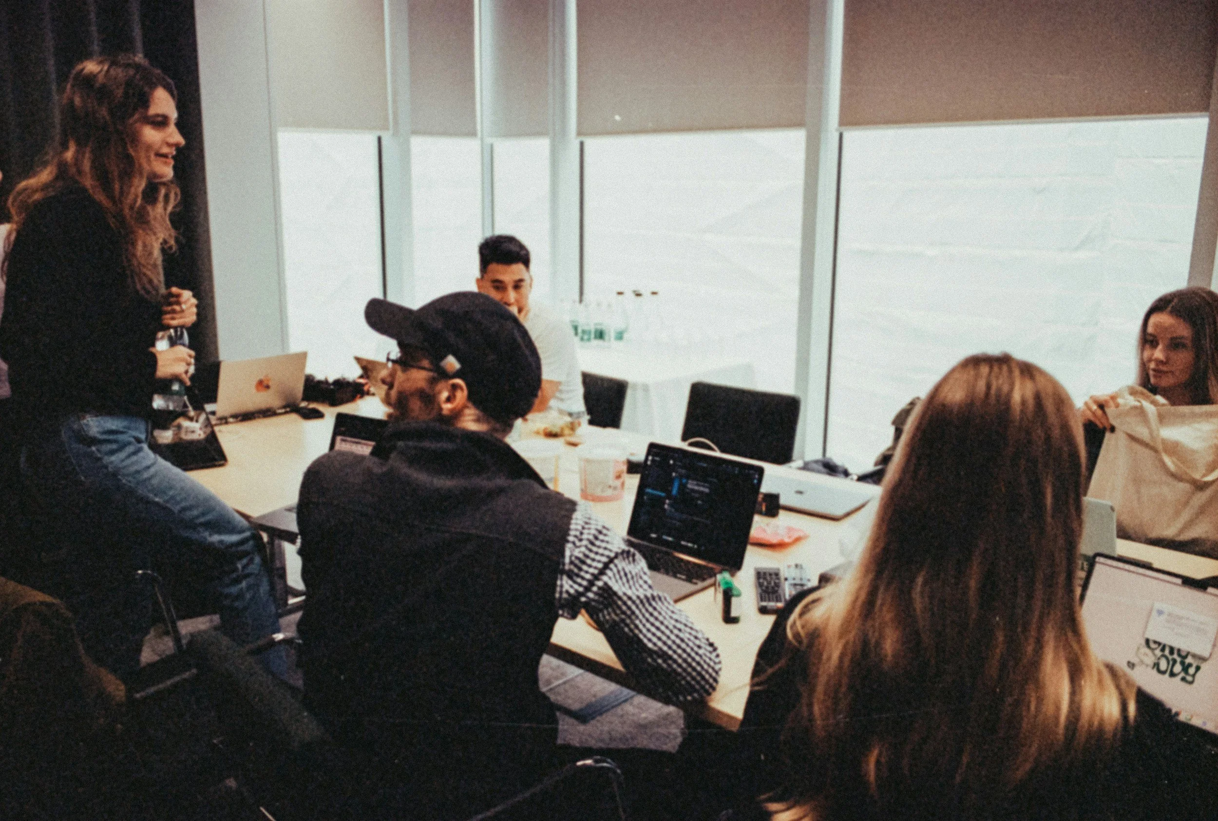 group of small business employees sitting around a meeting table for a working session