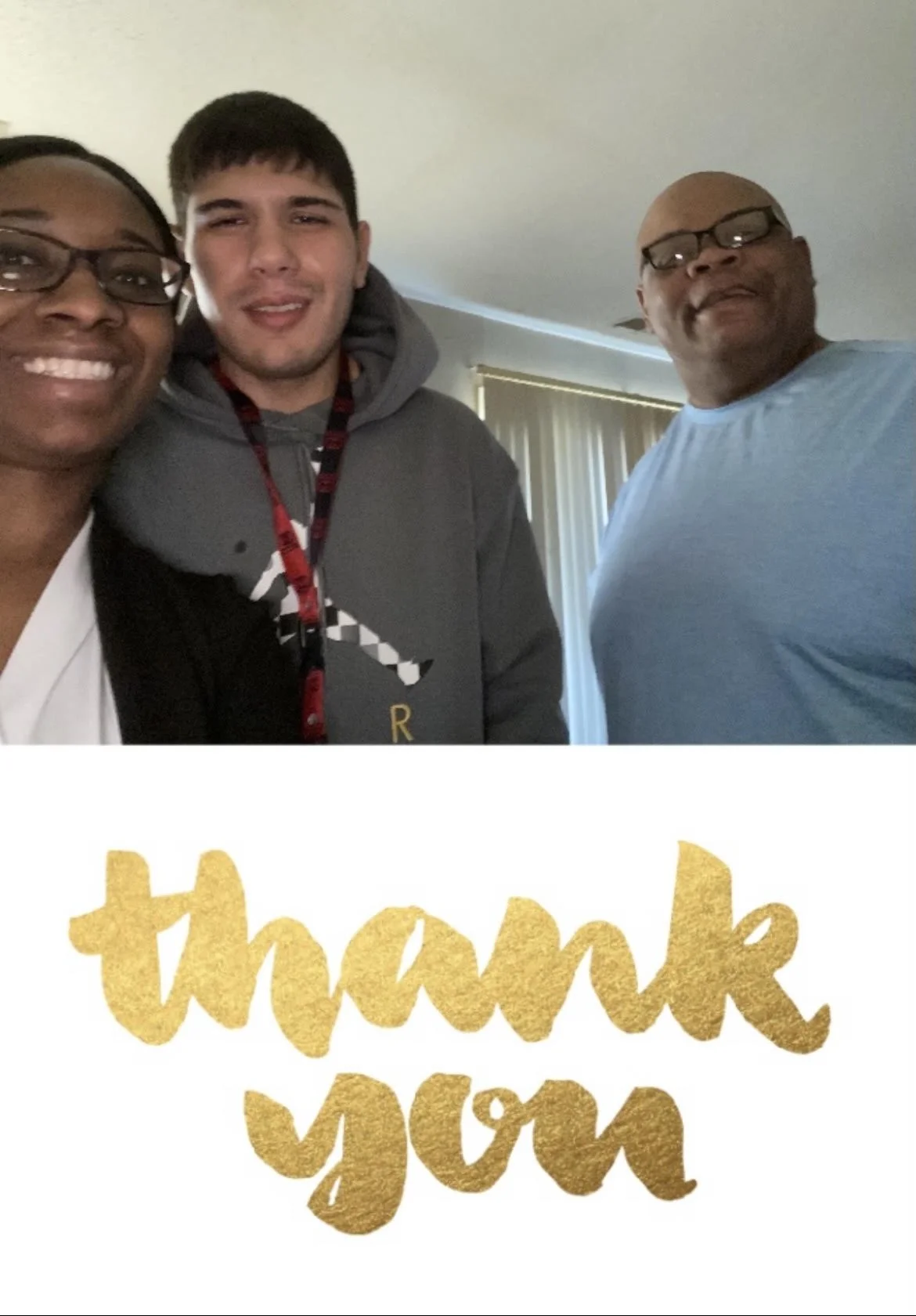 A group of three people taking a selfie in a room. Two men and one woman, smiling and wearing casual clothes, with a light-colored wall and vertical blinds in the background. Partially visible golden text saying 'thank you' at the bottom.