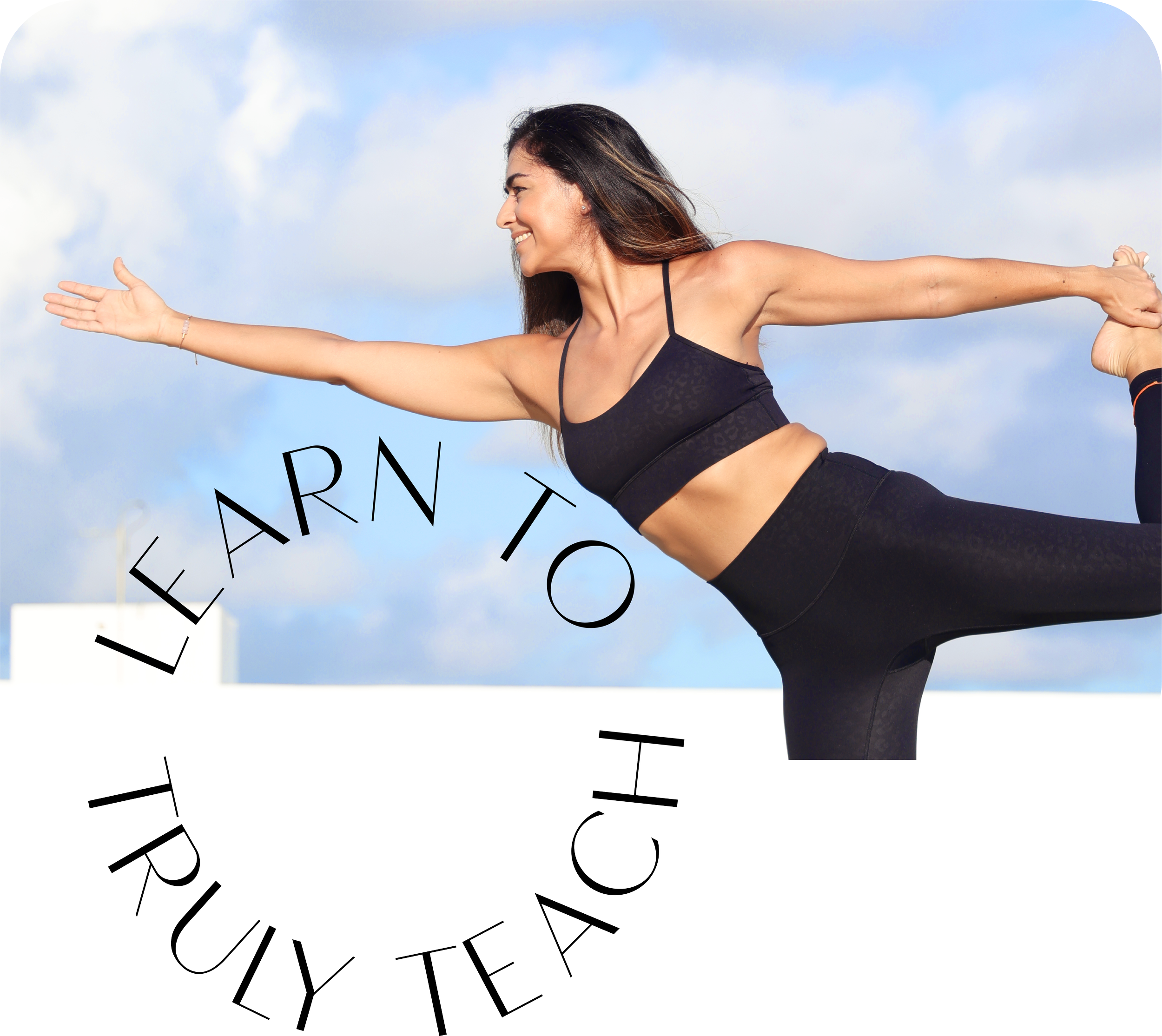 A woman in workout clothes practicing yoga outdoors against a blue sky with clouds, performing a balancing pose with a smile, supported by an instructor or partner.