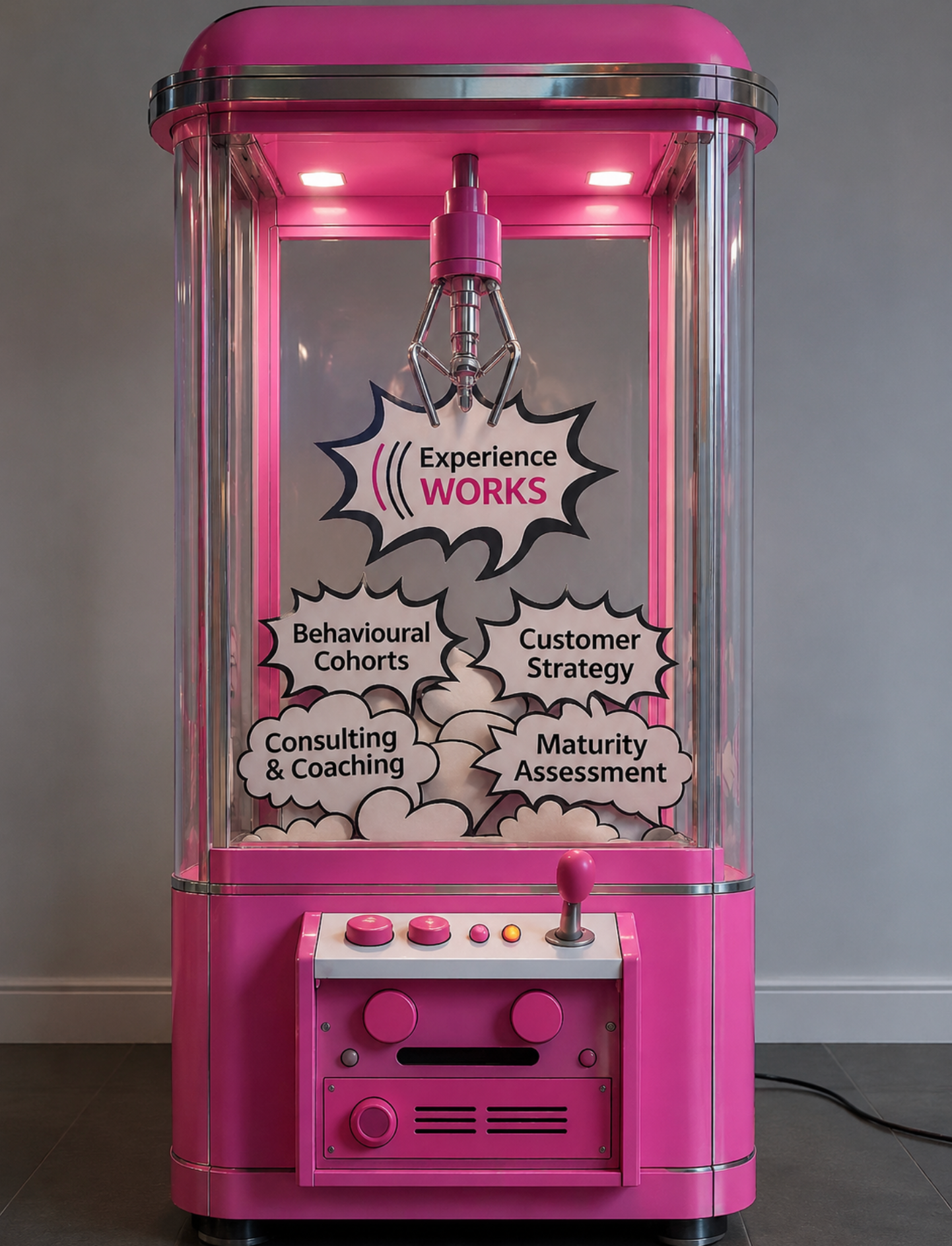 A pink arcade machine with a transparent glass front displaying words such as 'Experience WORKS', 'Behavioral Cohorts', 'Customer Strategy', 'Consulting & Coaching', and 'Maturity Assessment'. The machine has a joystick and buttons on the control panel at the bottom.