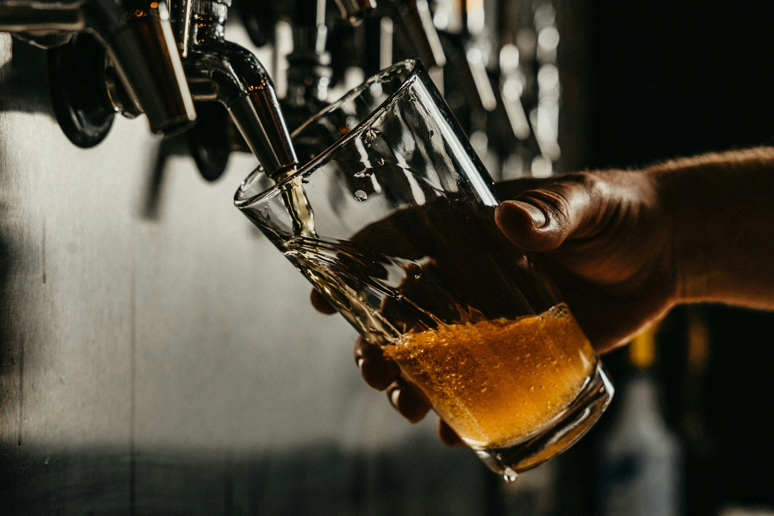 Fresh craft beer being poured from a tap at FreeFall Brewing Co., highlighting the brewery’s commitment to quality and flavor.