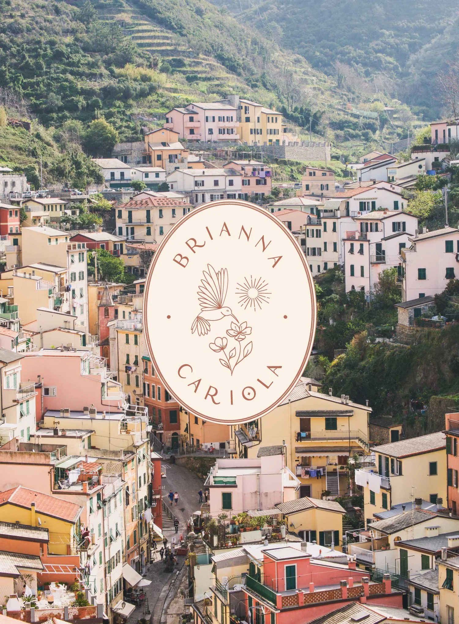 Brianna Cariola photography brand identity alternate oval badge logo overlaid on a travel photograph of the colorful hillside village of Riomaggiore in Cinque Terre, Italy.