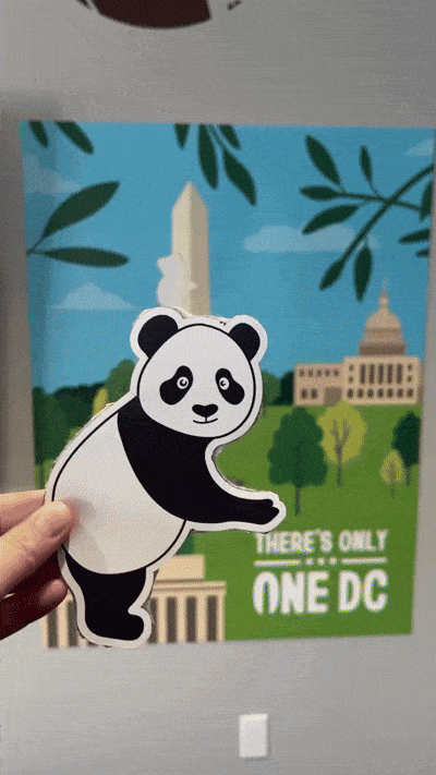 "Destination DC open house event panda character die-cut sticker being held up in front of the printed Washington Monument illustration poster reading 'There's Only One DC’.