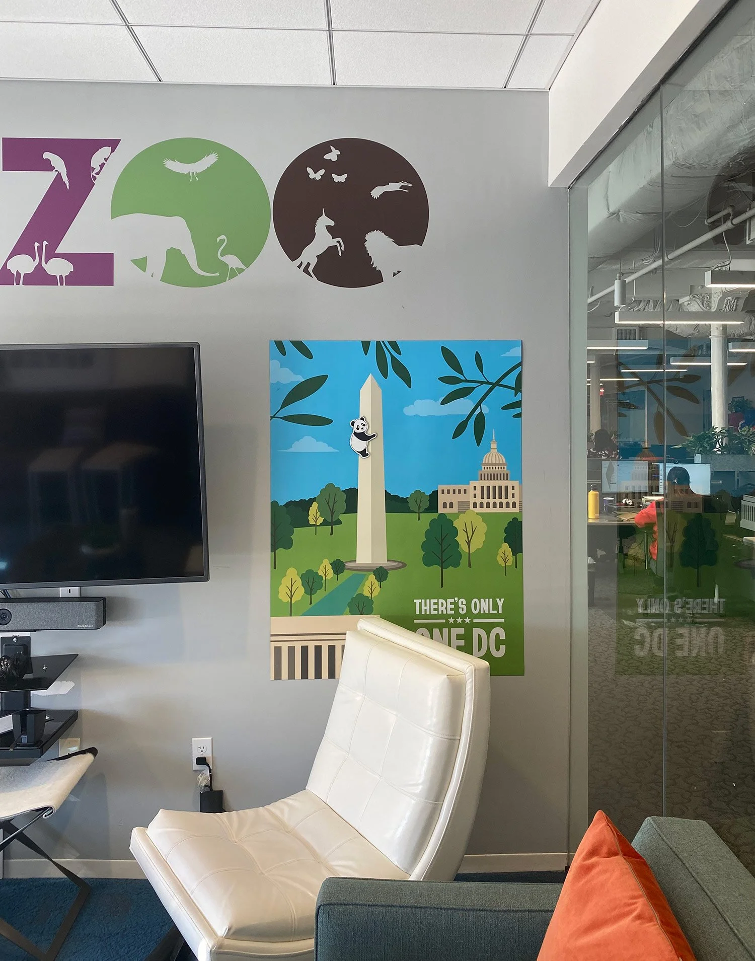 Destination DC 'There's Only One DC' Washington Monument and panda illustration event poster displayed on the wall of a Smithsonian National Zoo themed office meeting room.