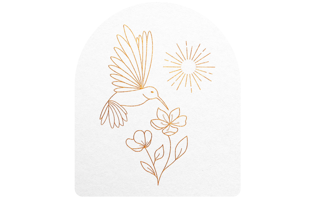 Yasmine Design Co. – Brianna Cariola pictorial logo print mockup in gold foil, featuring a delicate hummingbird, sunburst, and floral illustration on an arch-shaped card