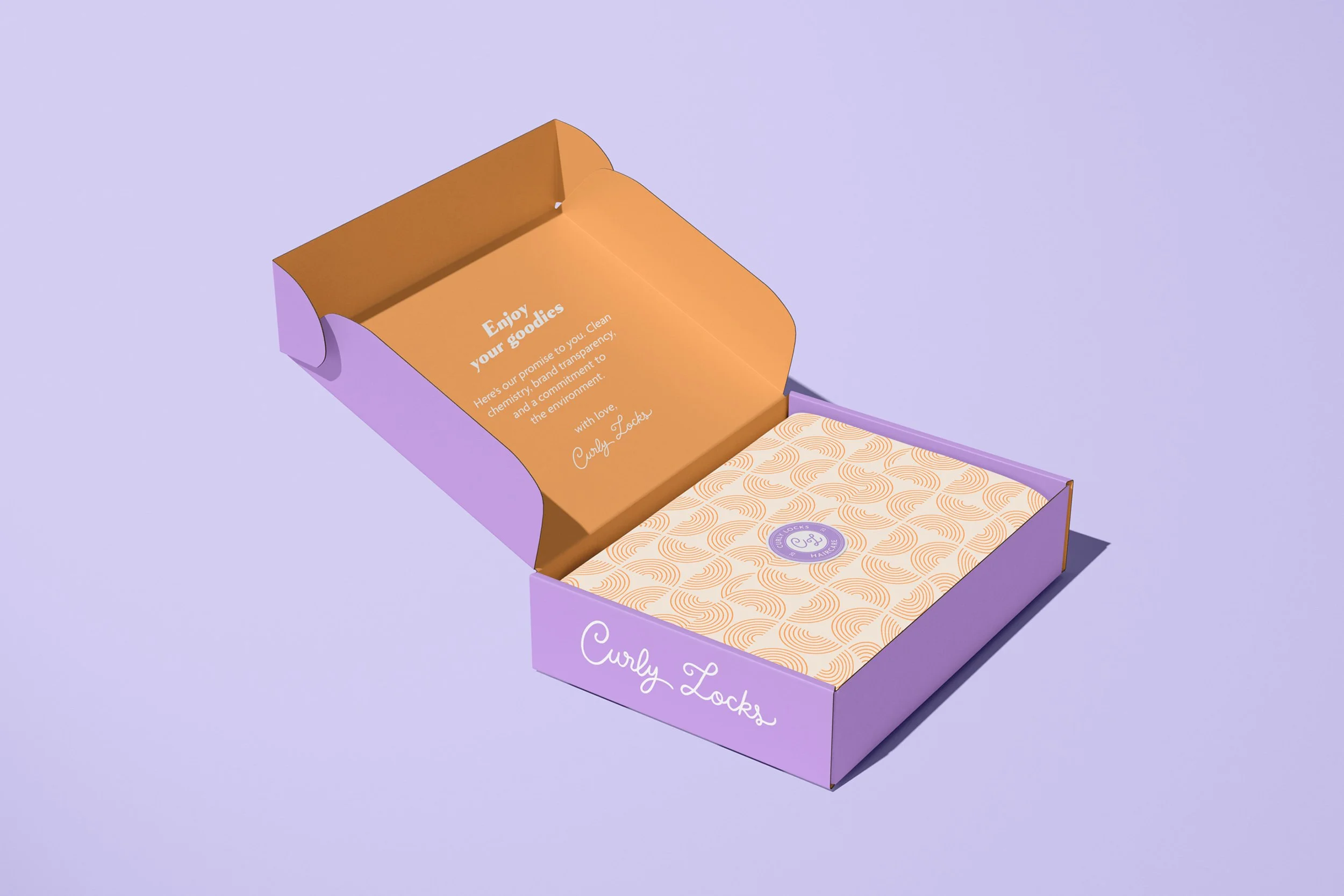 Yasmine Design Co. – Curly Locks Haircare brand packaging design mockup featuring an open lavender mailer box with a custom curly hair pattern, warm gold interior, and branded tissue paper.