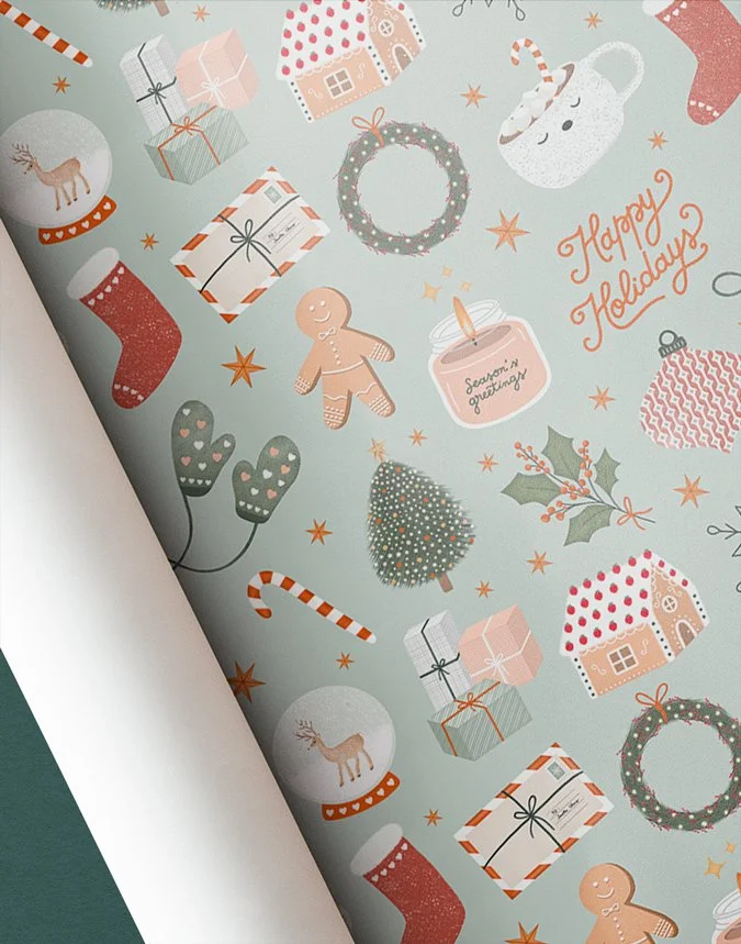 Festive cozy Christmas wrapping paper design mockup in sage green featuring illustrated holiday icons including gingerbread men, snow globes, stockings, wreaths, candy canes, and Happy Holidays script lettering.