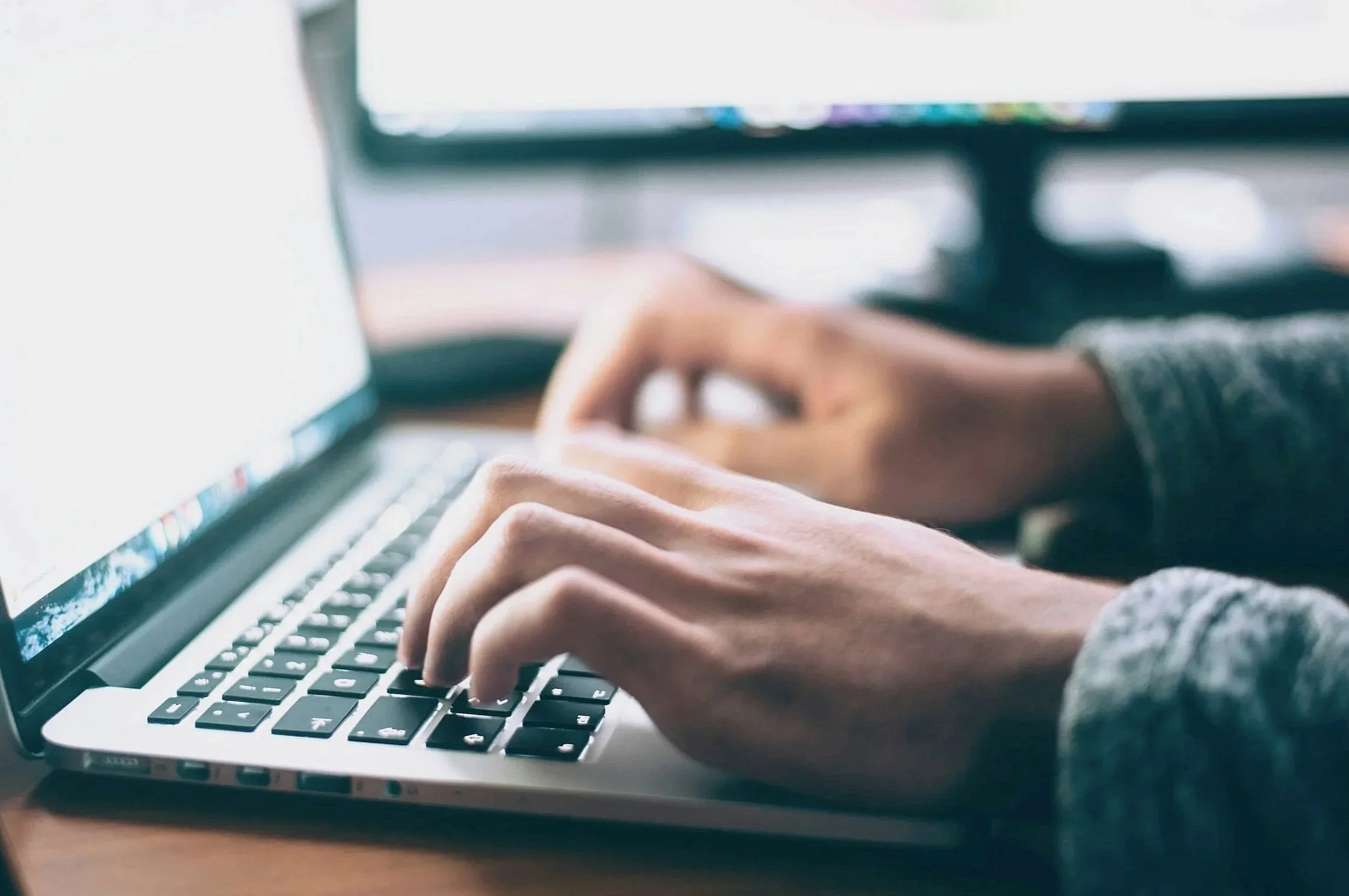 Person typing on a laptop keyboard