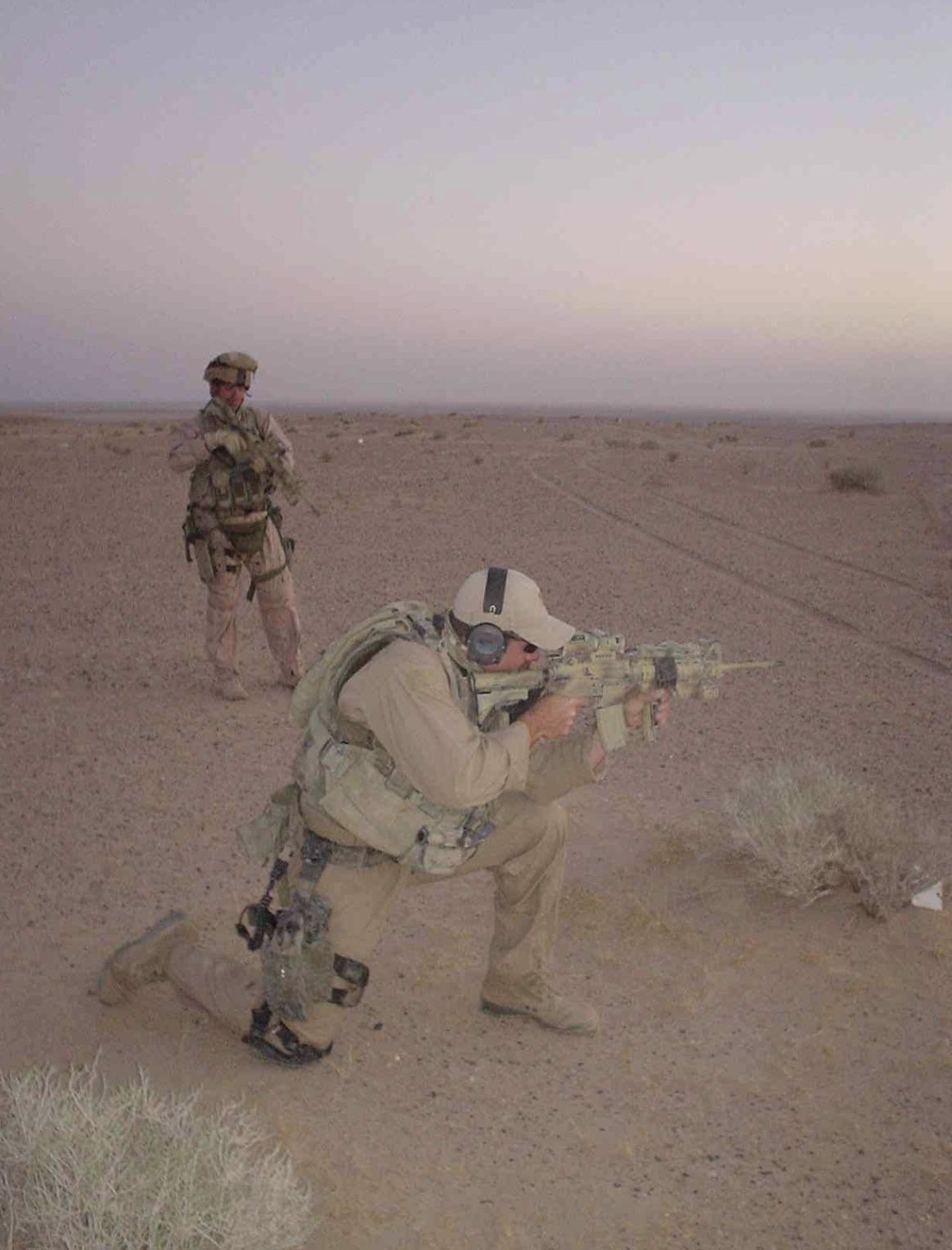 Thomas Folger with teammate performing low-light live fire training in the Iraqi desert