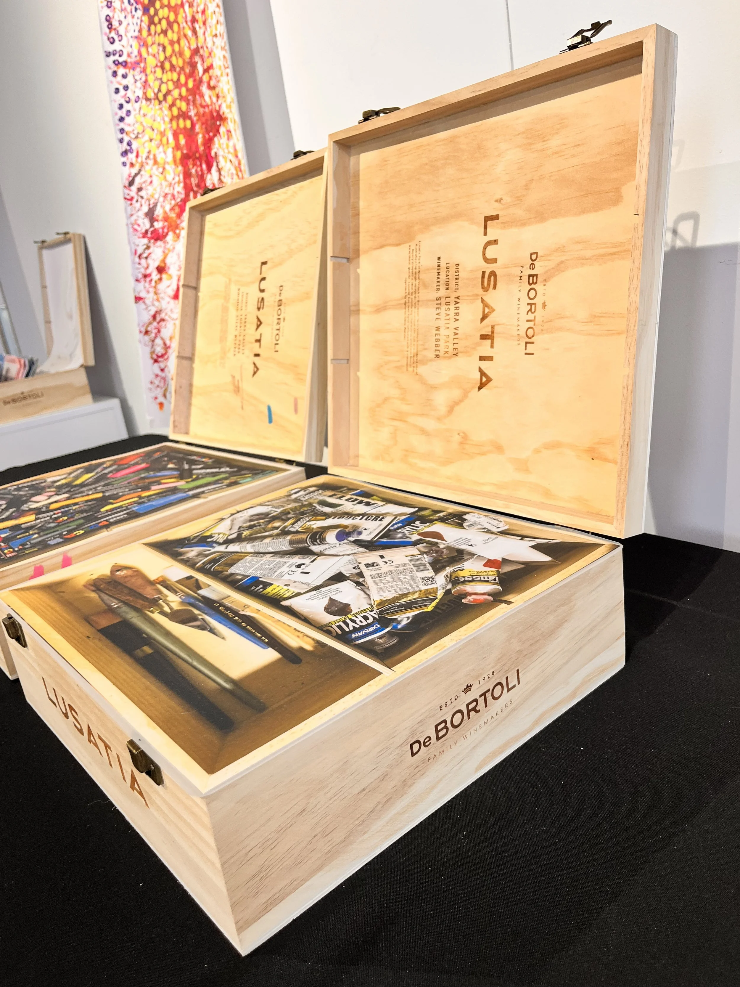 two pine boxes next to each other containing photo of art materials