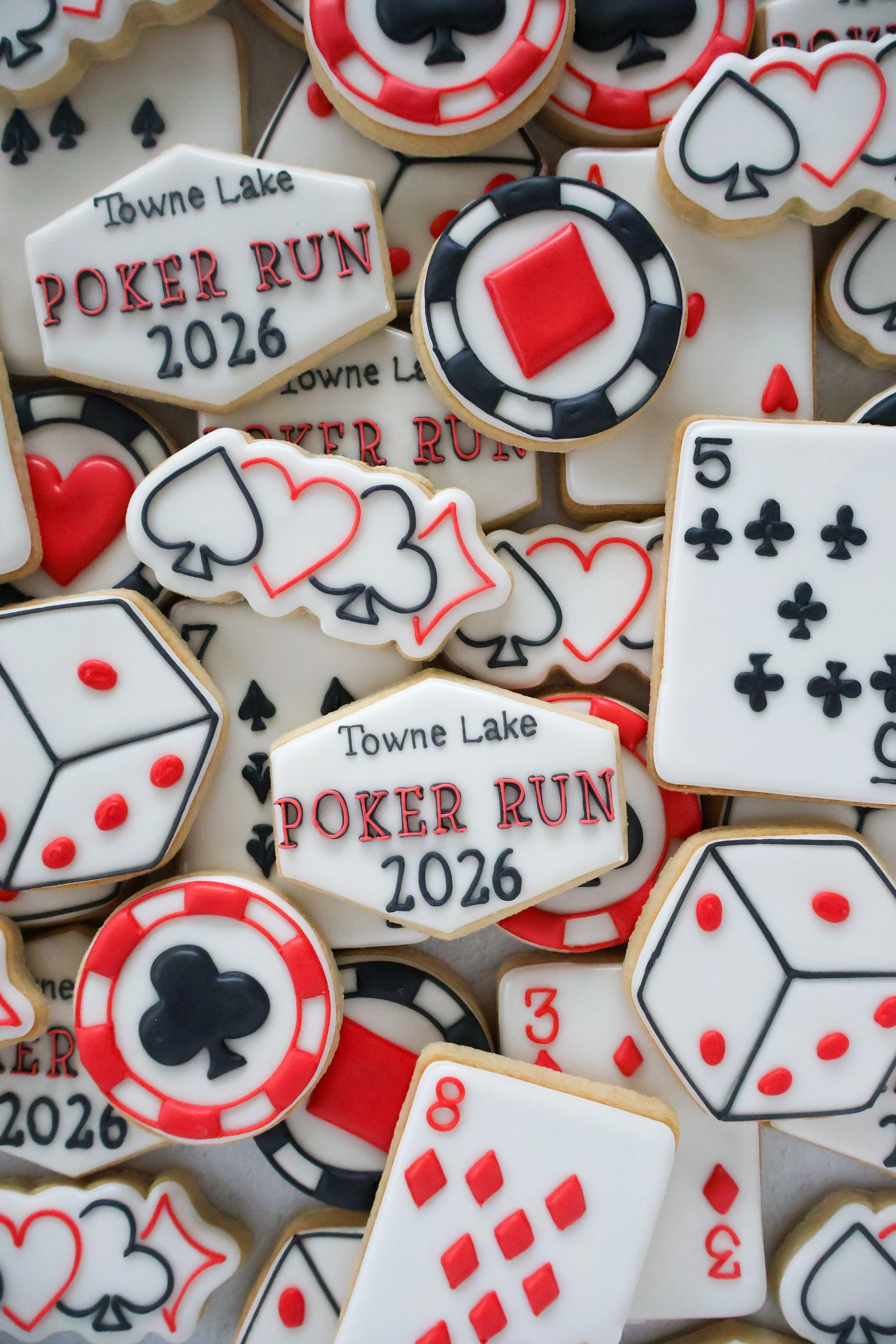 Decorated cookies with poker themes, including playing cards, poker chips, and a sign that reads 'Towne Lake Poker Run 2026.'