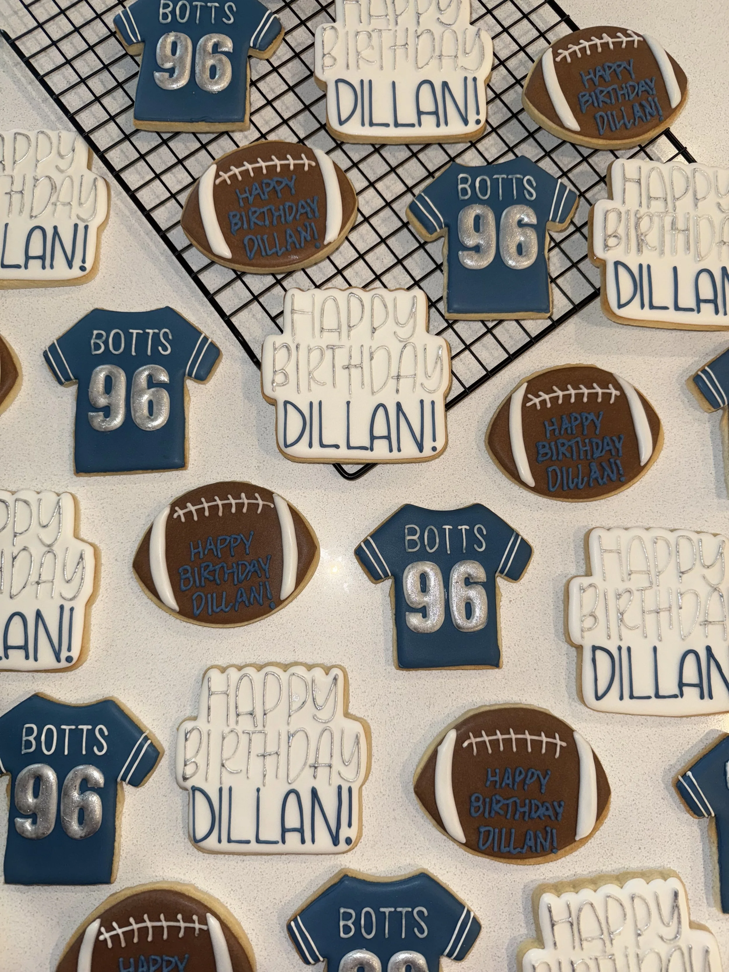 Decorated cookies with football themes and birthday messages for Dillian, including cookies shaped and decorated like jerseys, footballs, and birthday greetings.