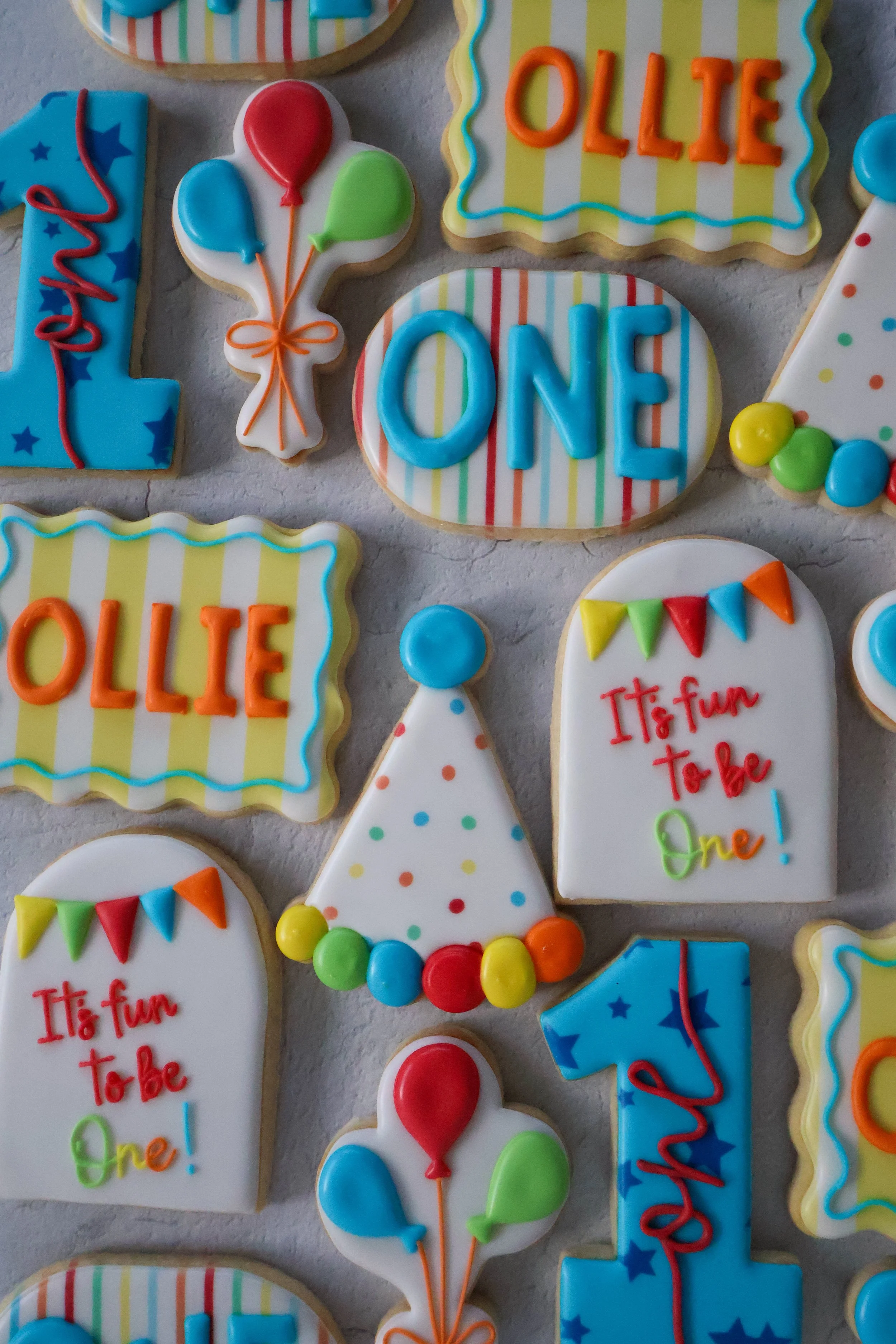 Decorated birthday cookies with colorful icing, balloons, and birthday messages.